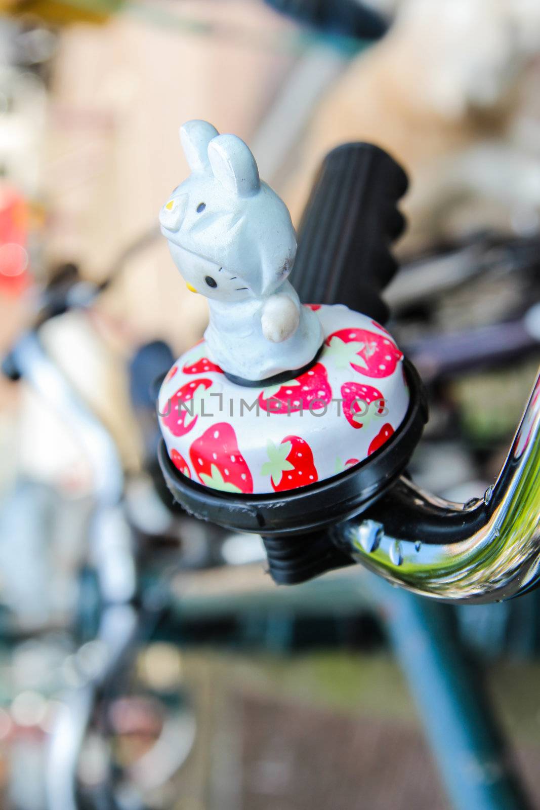 Detail of bike bell toy parked in the street by doble.d