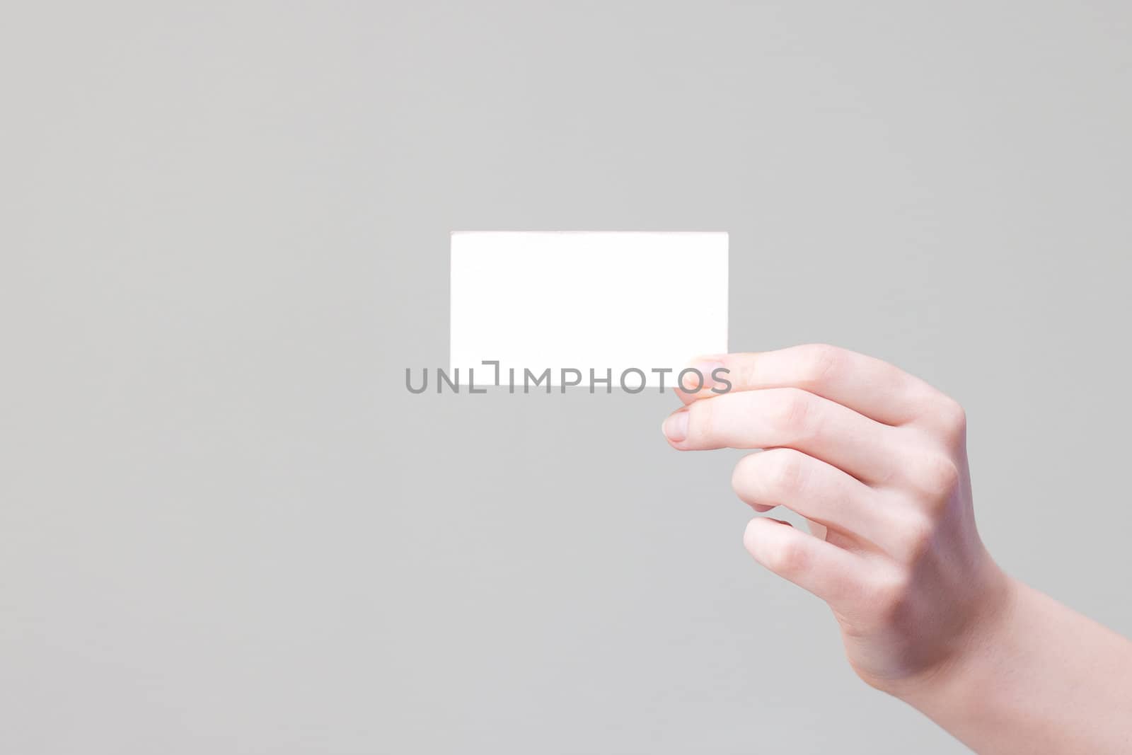 bussines card in hand for your information and logo in a grey background