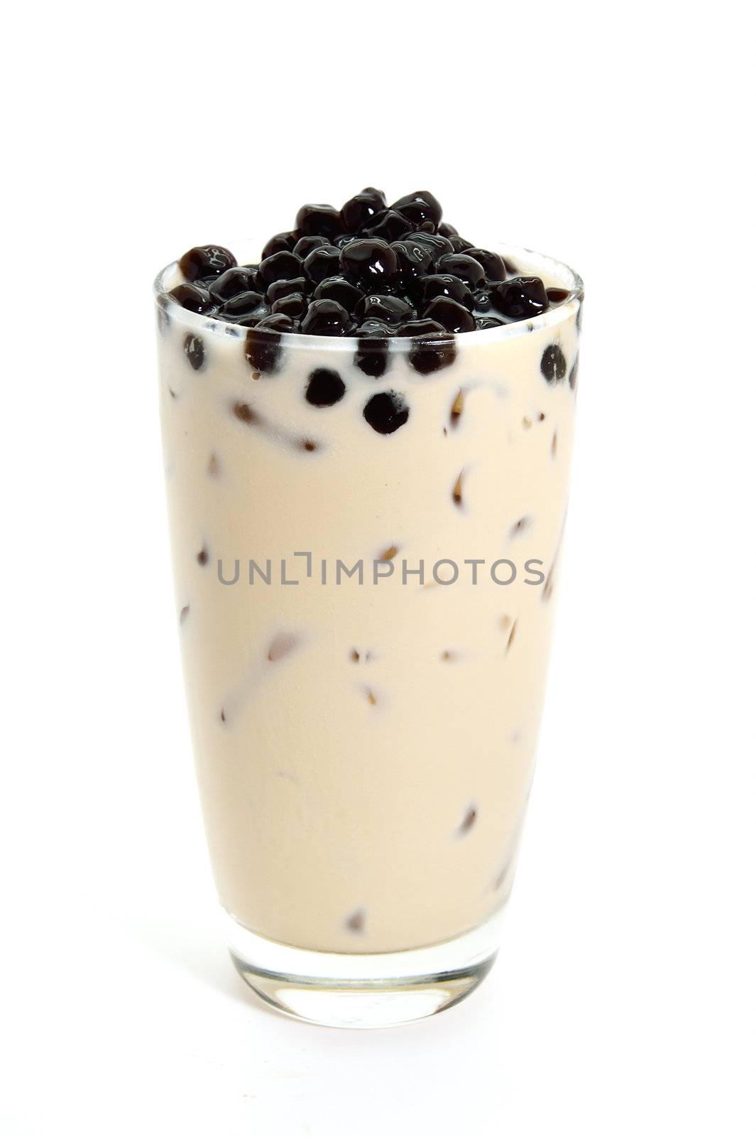 Milk tea with black jelly in clear glass on white background, Thai style