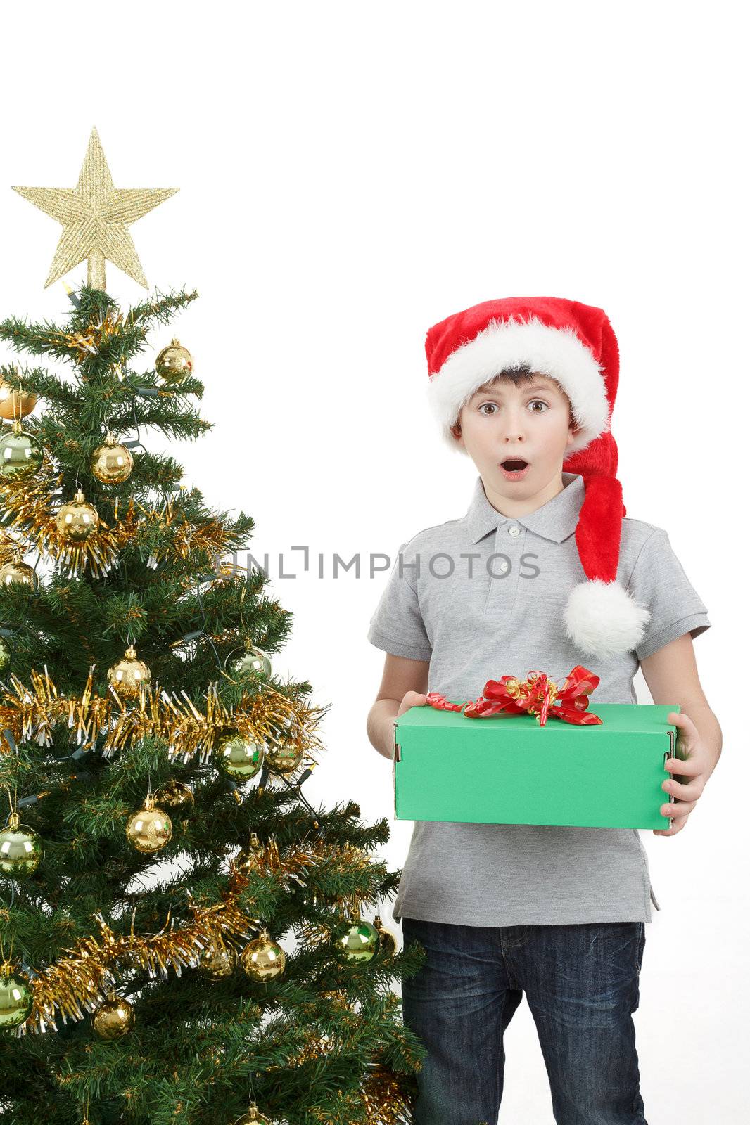 surprised boy in santa hat with christmas present on white background