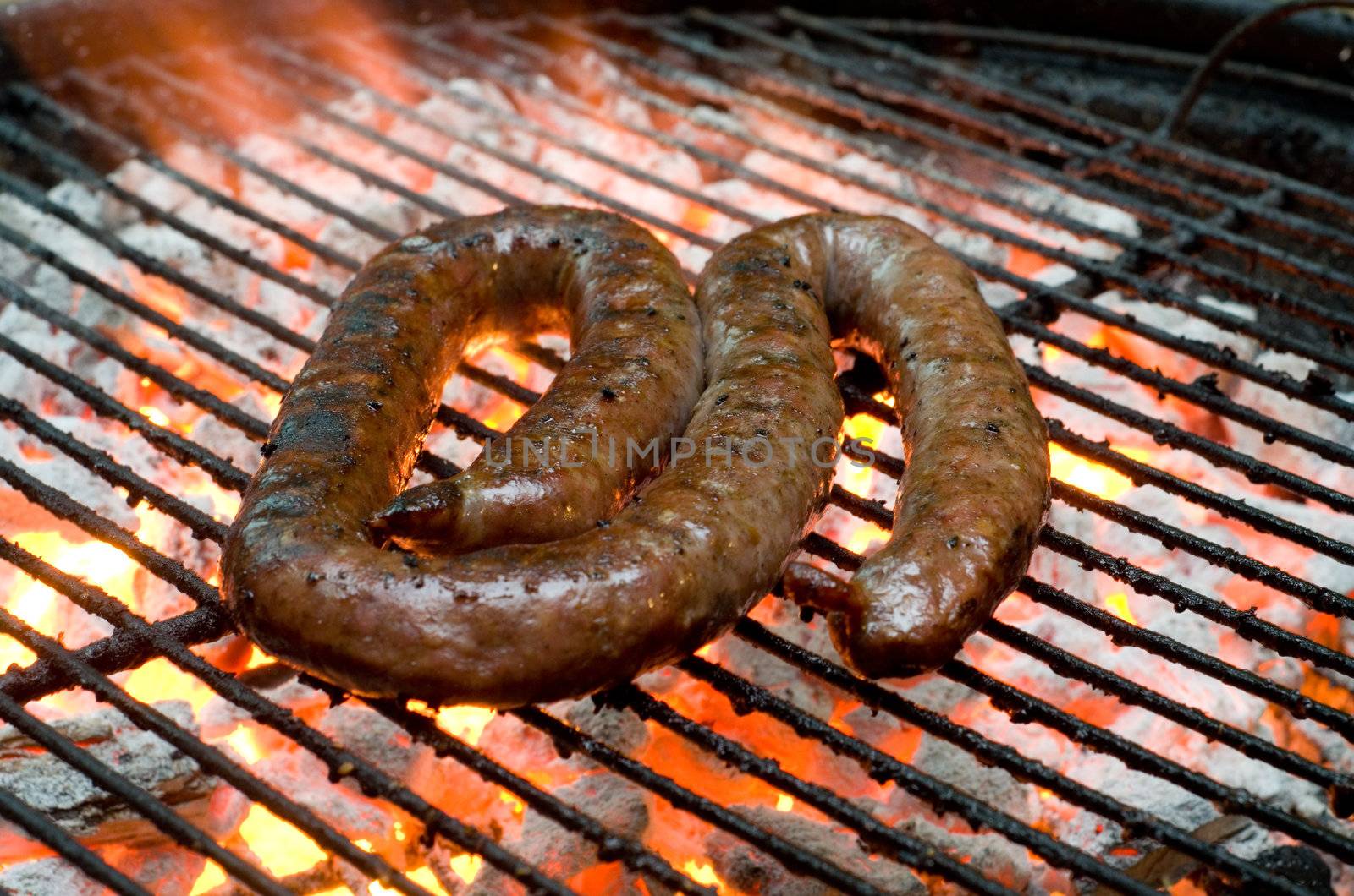 Tradtional South African braai barbecue borewors sausage on fire