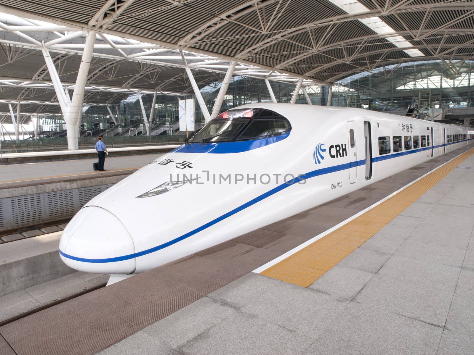 GUANGZHOU, CHINA - JULY 8: Modern train waits at platform on July 8, 2010 in Guangzhou station, Guangzhou, China. China invests in fast and modern railway, trains with speed over 340 km/h.