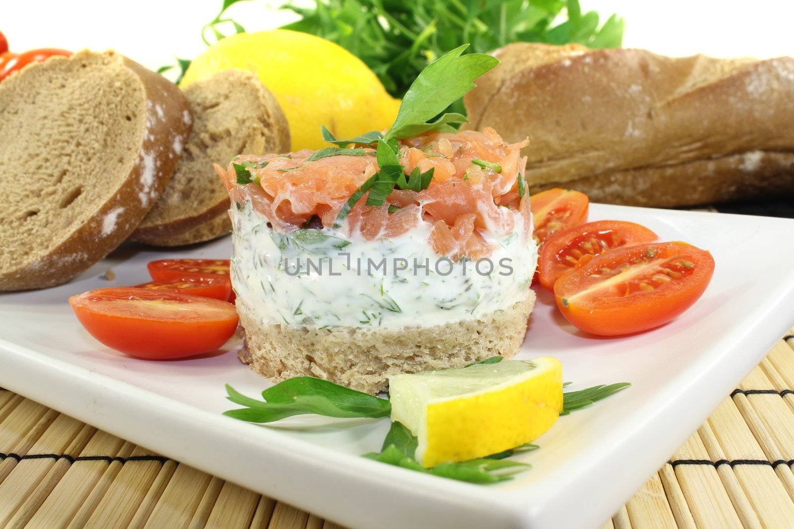 salmon tartare with creme fraiche, bread, parsley and lemon