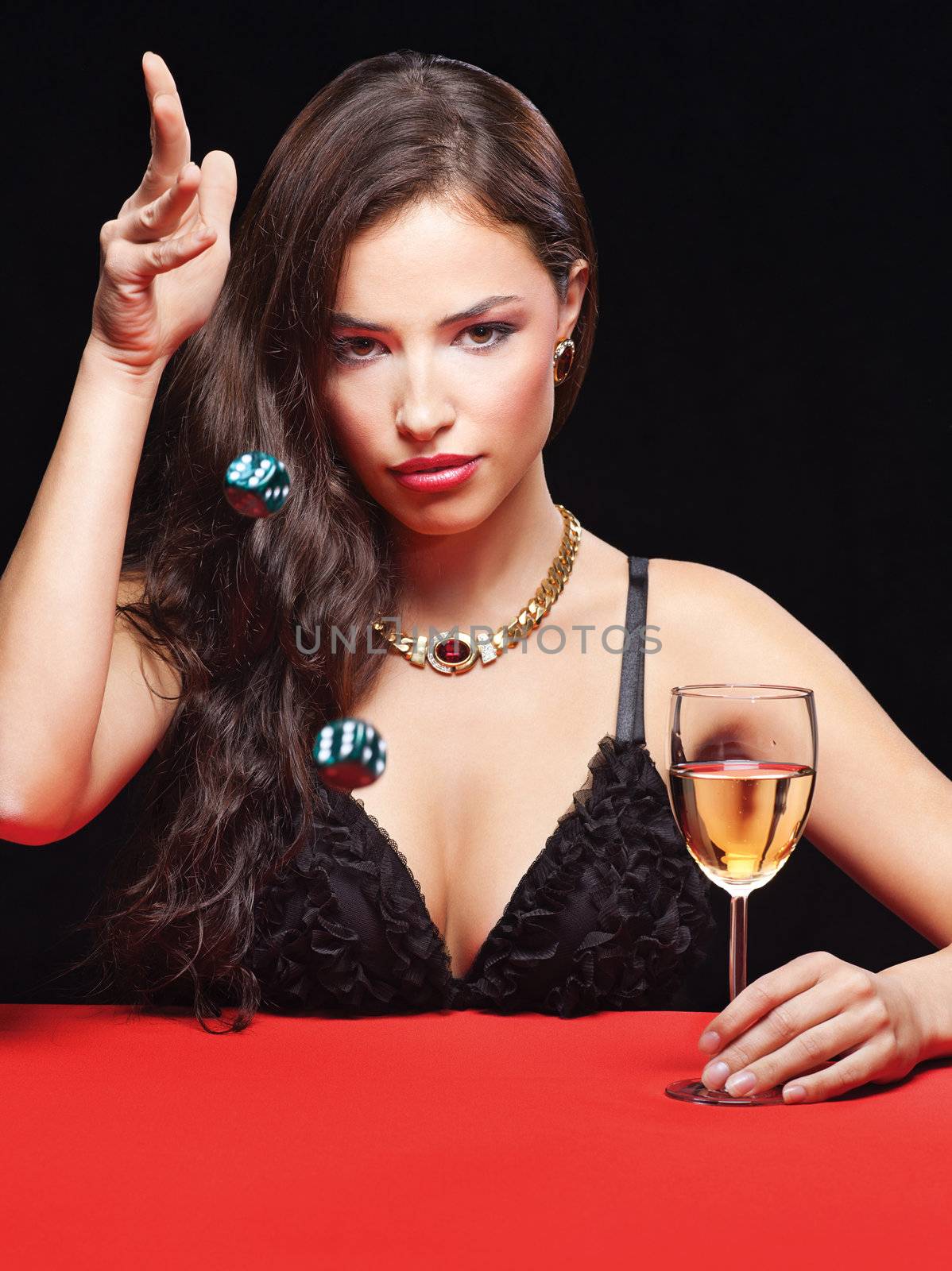 pretty young woman throwing dices on red table