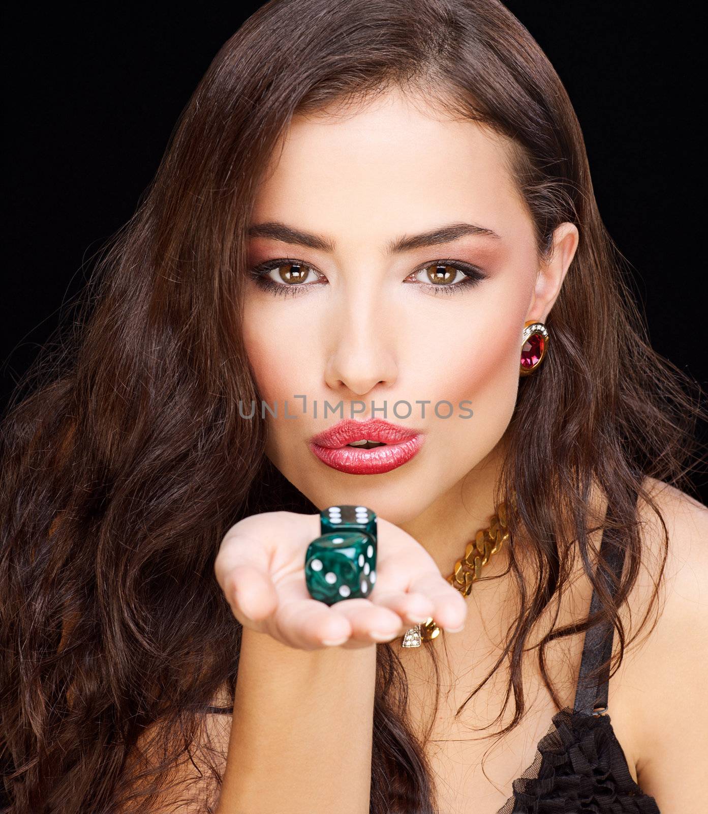 pretty young woman holding gamble dices on black background