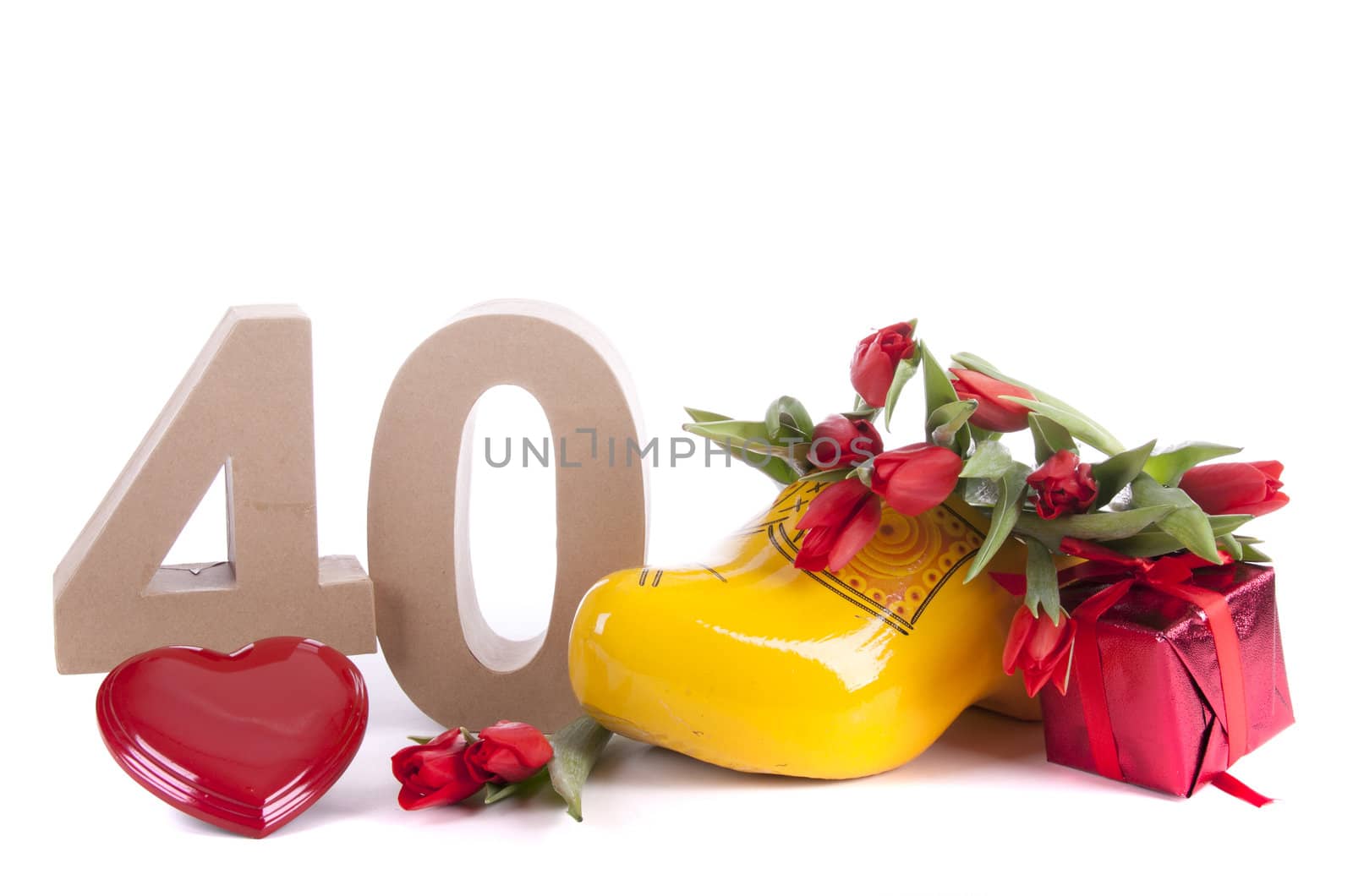 Number of age in a colorful studio setting and Dutch looking attributes like a clog woonden shoe and tulips