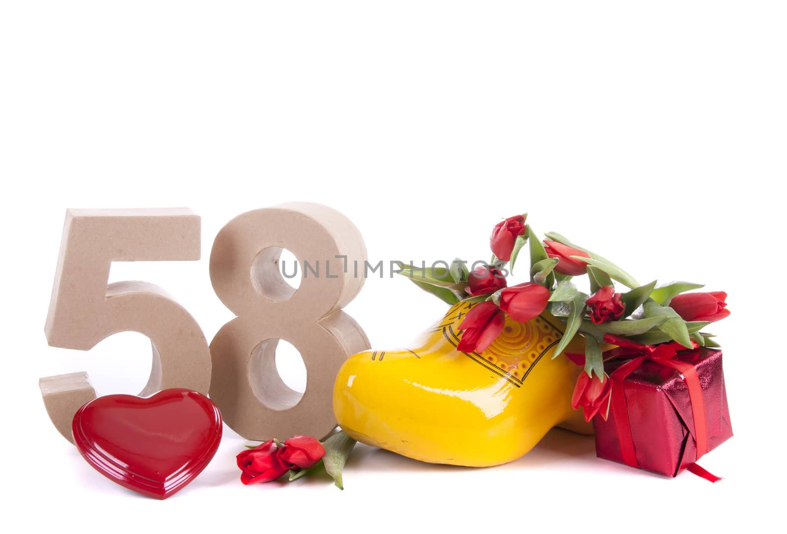 Number of age in a colorful studio setting and Dutch looking attributes like a clog woonden shoe and tulips