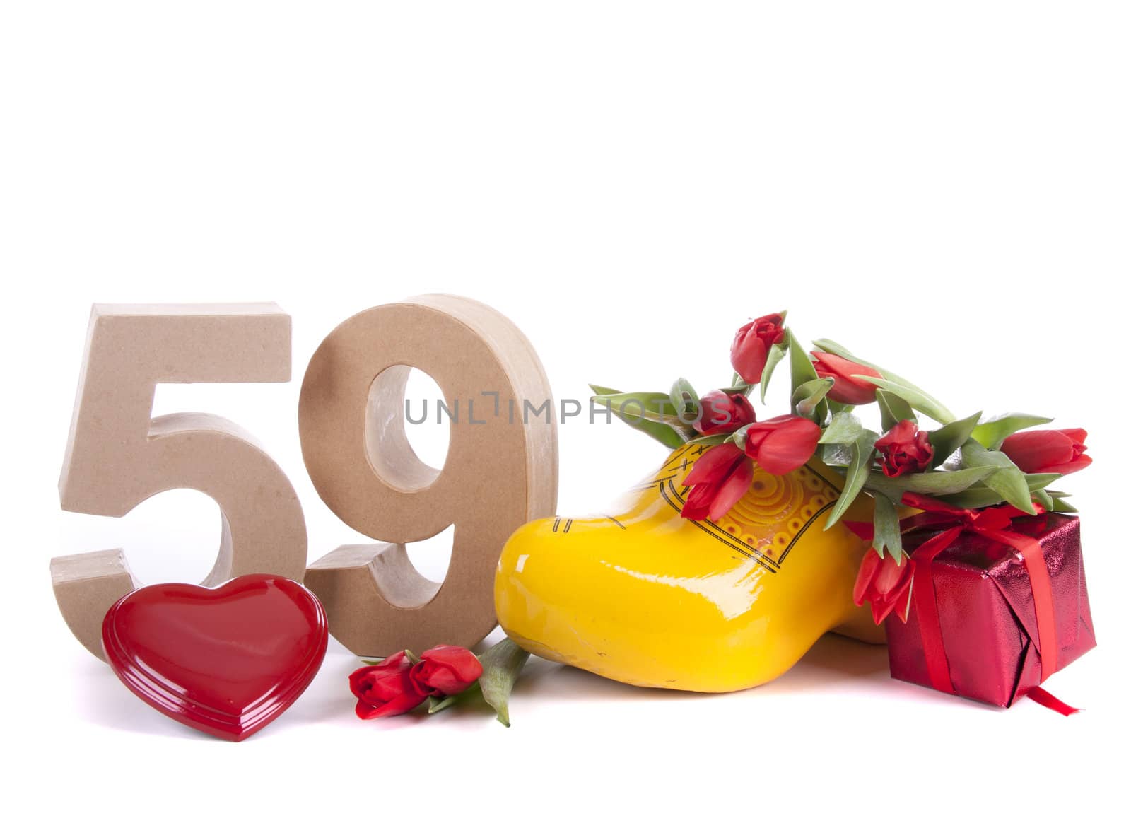 Number of age in a colorful studio setting and Dutch looking attributes like a clog woonden shoe and tulips