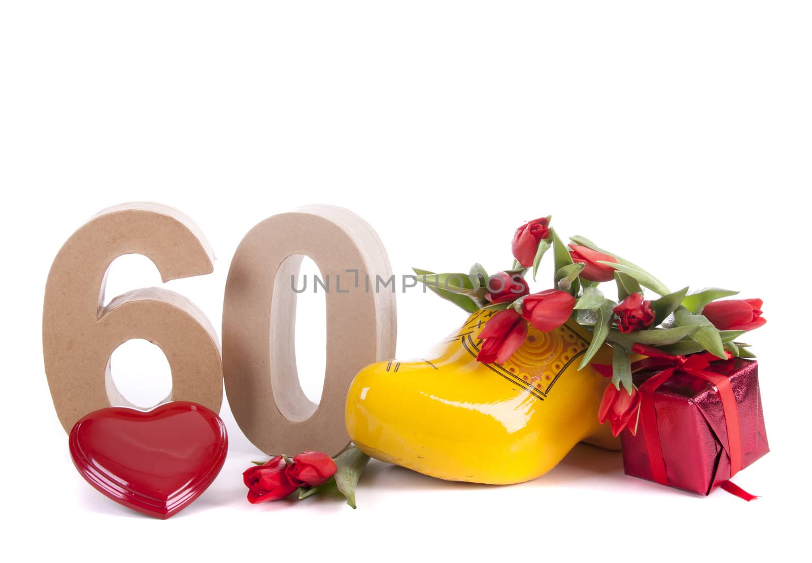 Number of age in a colorful studio setting and Dutch looking attributes like a clog woonden shoe and tulips