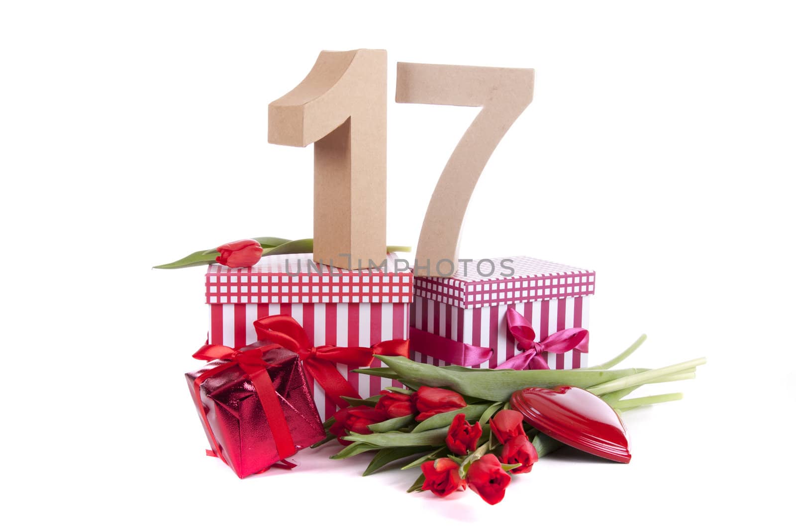 Number of age in a colorful studio setting with a red heart and gifts and tulips