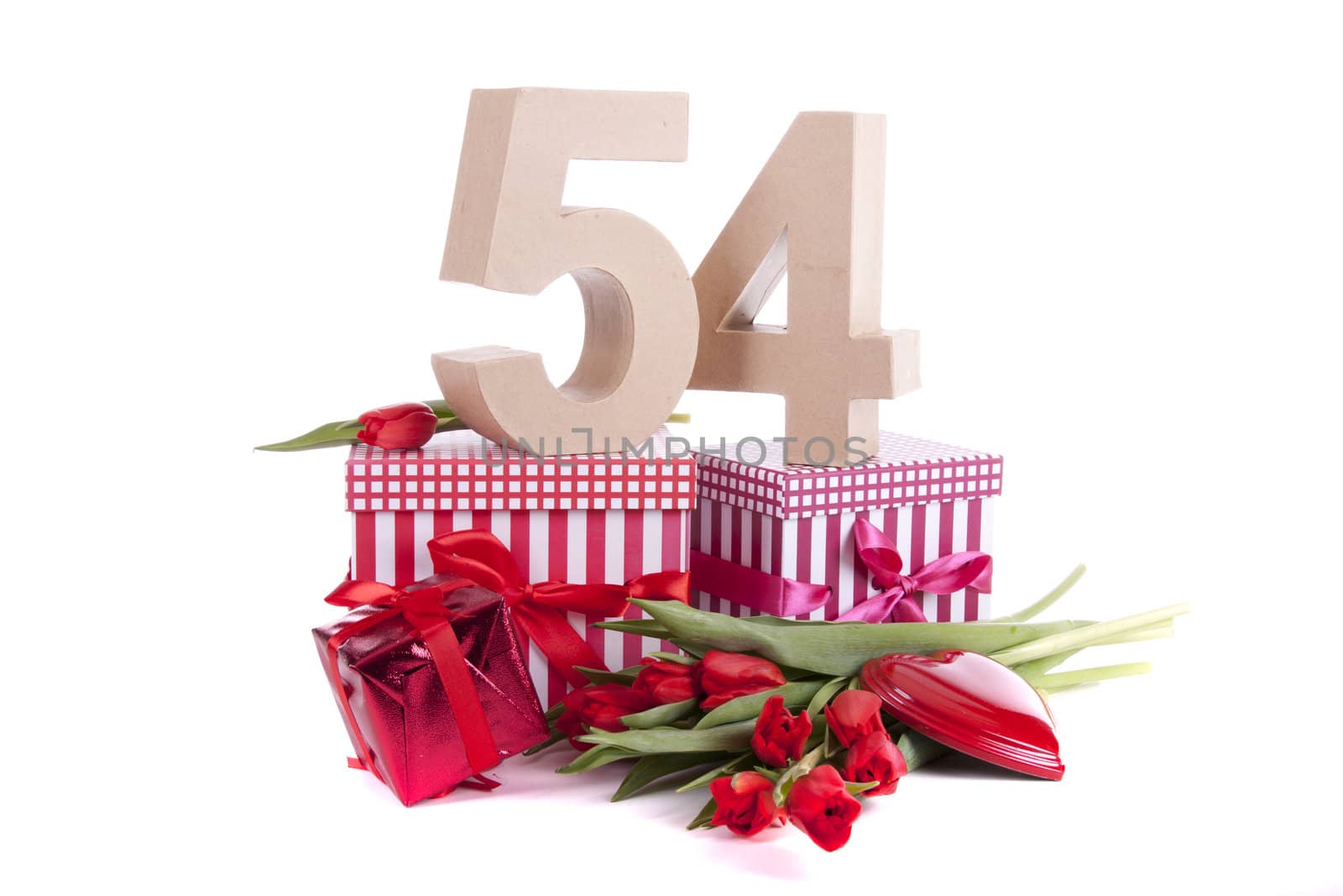 Number of age in a colorful studio setting with a red heart and gifts and tulips