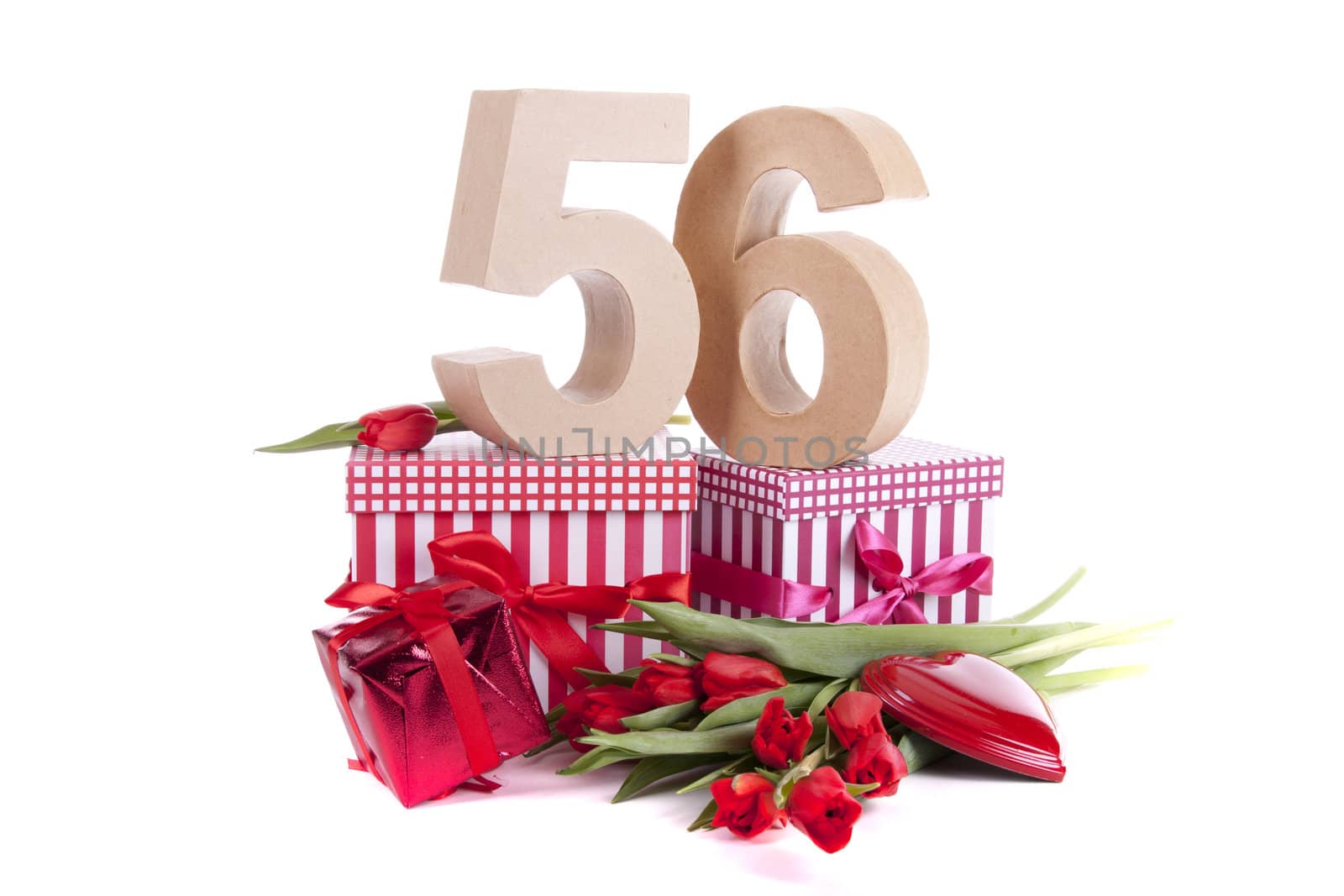 Number of age in a colorful studio setting with a red heart and gifts and tulips