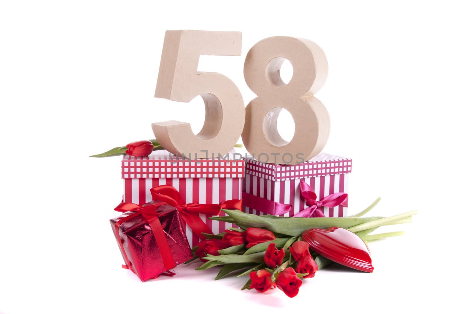 Number of age in a colorful studio setting with a red heart and gifts and tulips