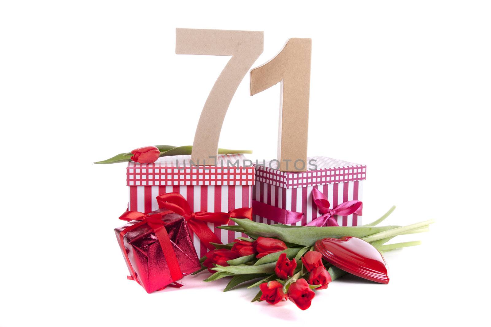 Number of age in a colorful studio setting with a red heart and gifts and tulips