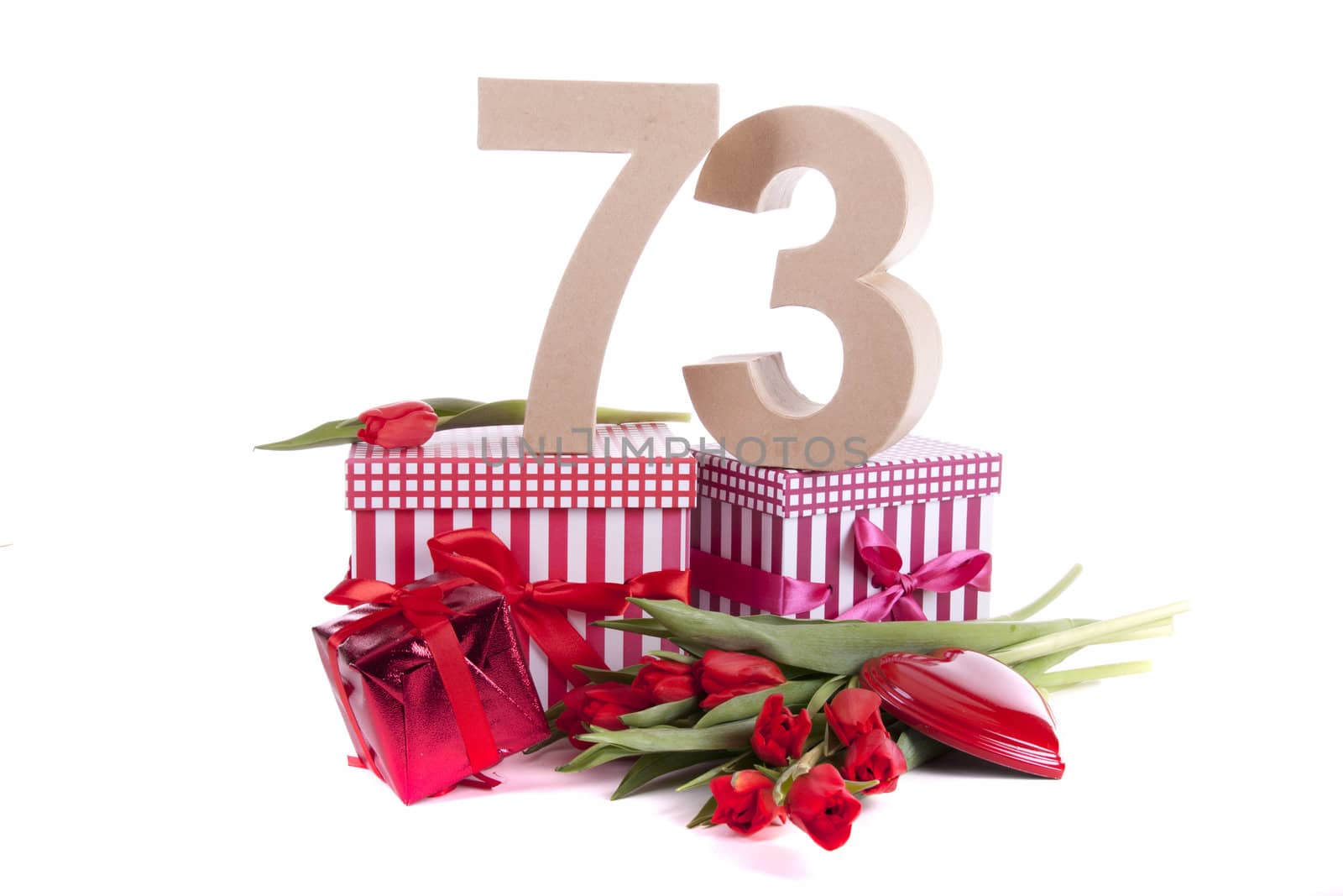 Number of age in a colorful studio setting with a red heart and gifts and tulips