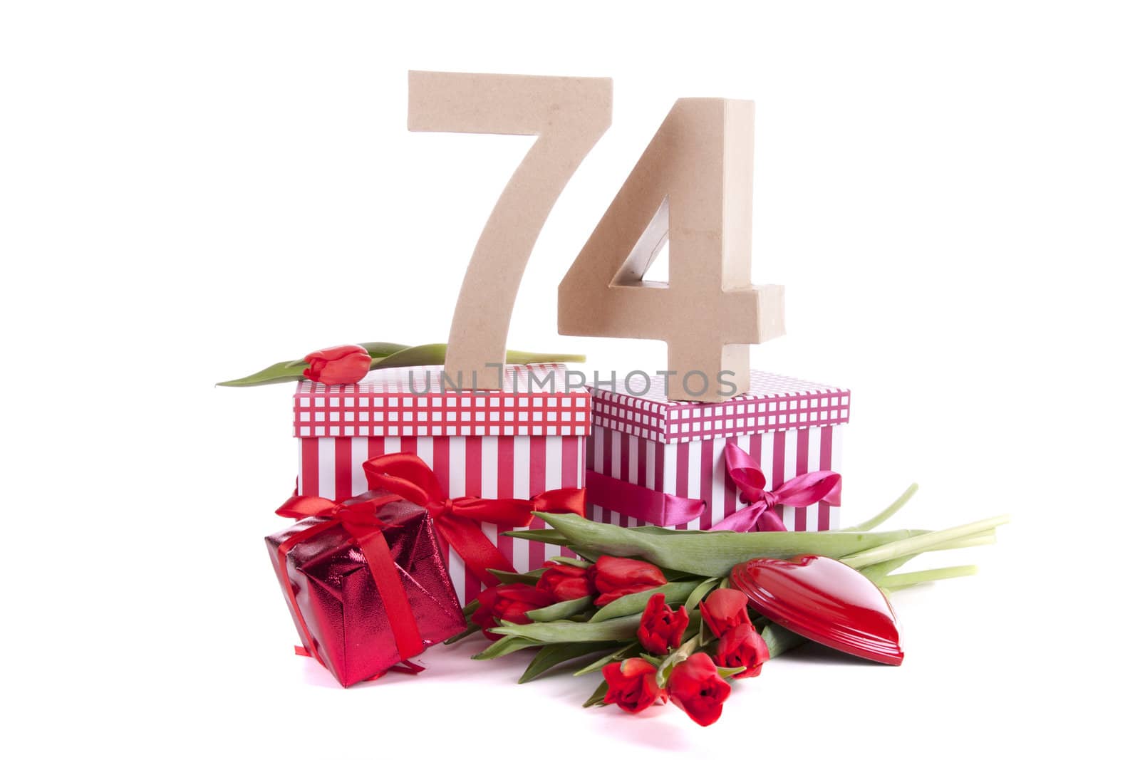 Number of age in a colorful studio setting with a red heart and gifts and tulips