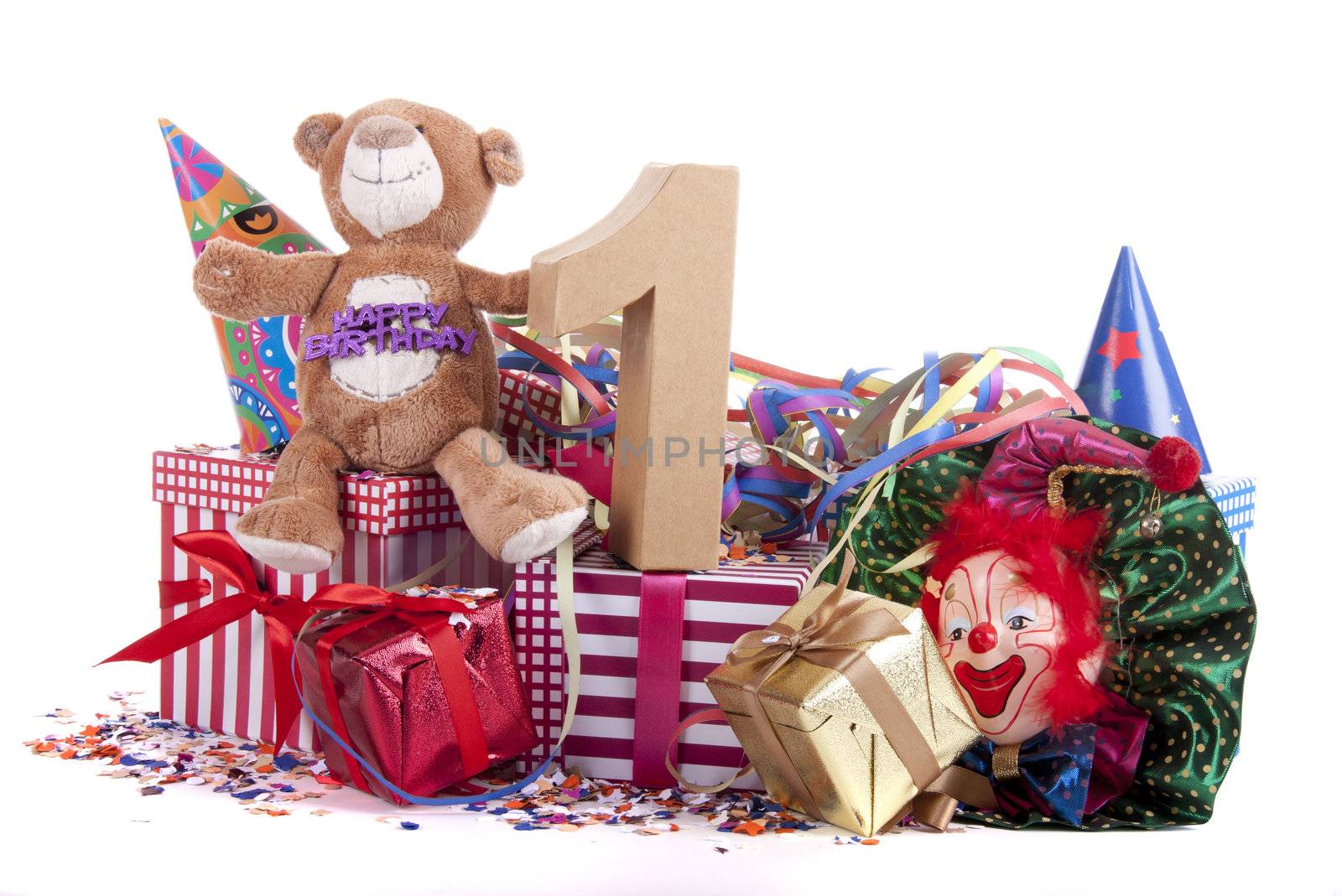 Number of age in a colorful studio setting with paper party hats, a red heart and gifts on a bottom of confetti for  childrens birthday party

