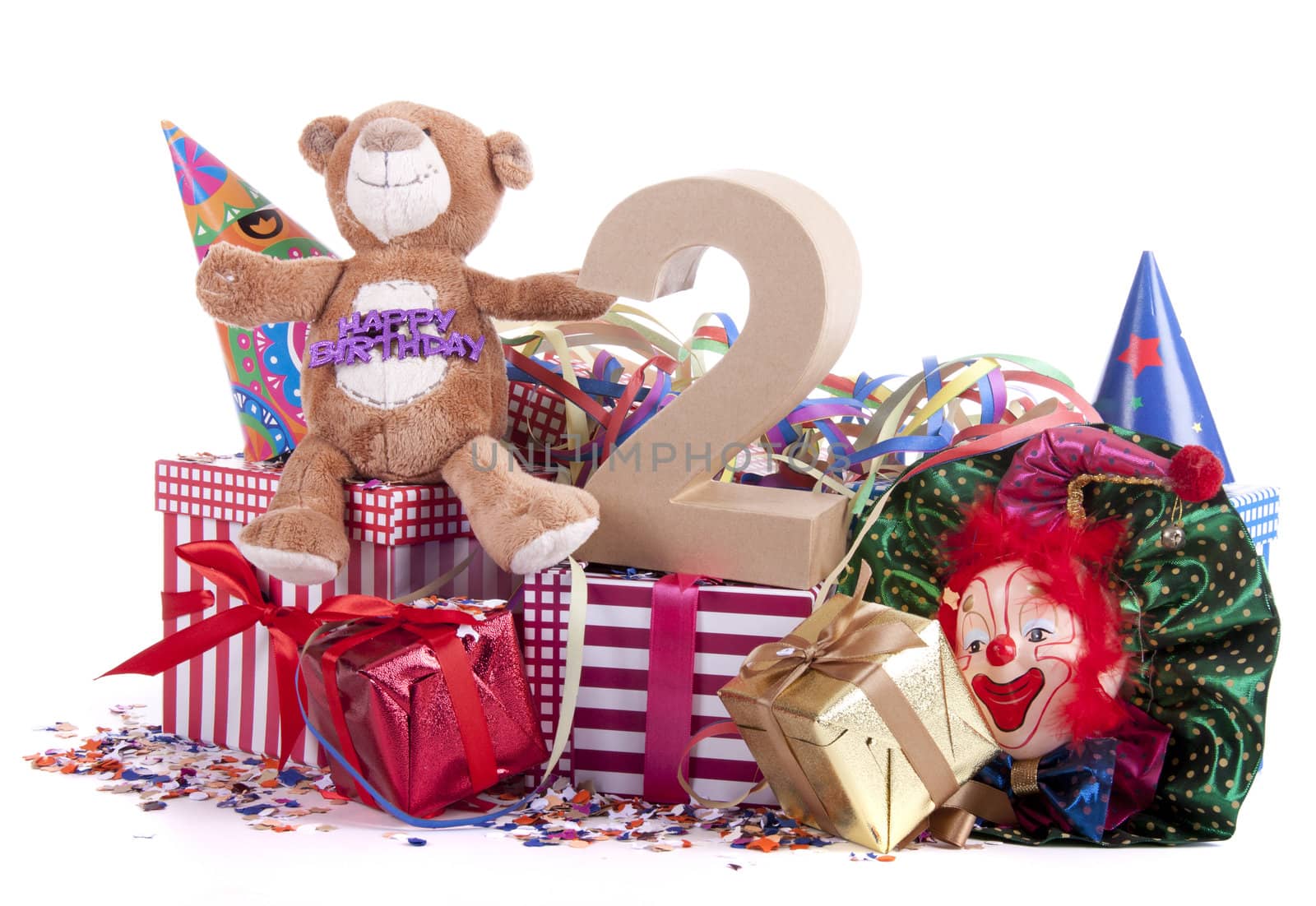 Number of age in a colorful studio setting with paper party hats, a red heart and gifts on a bottom of confetti for  childrens birthday party

