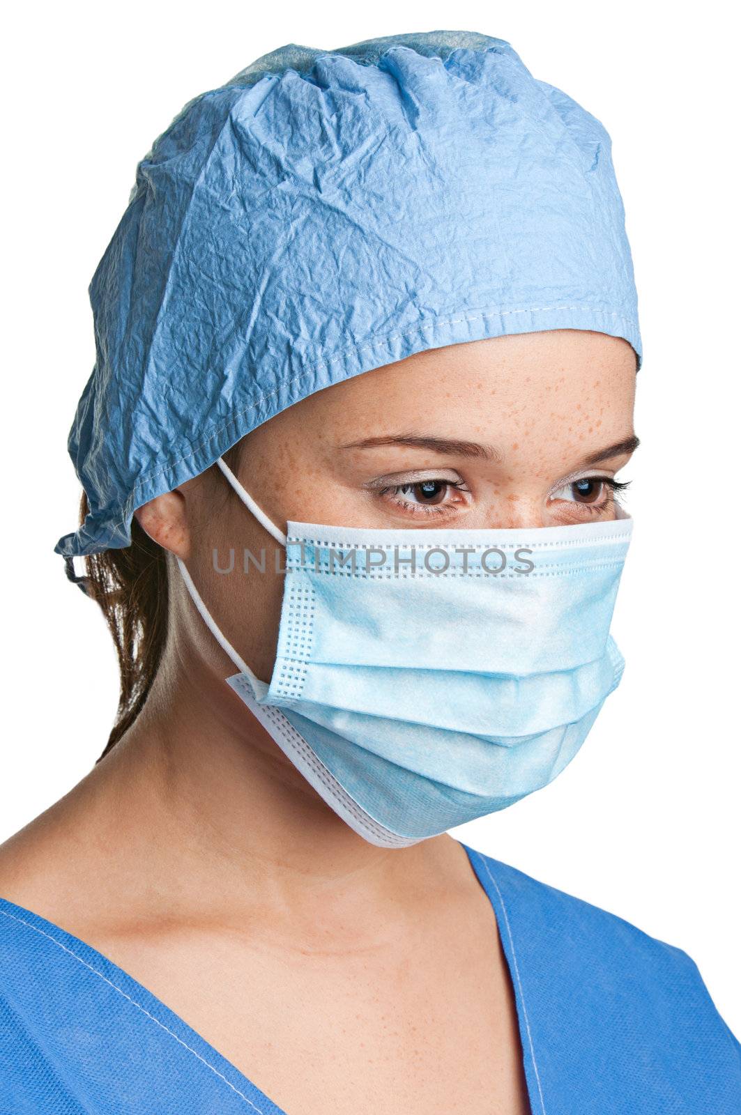 Young female surgeon with scrubs, holding a face mask on a white background