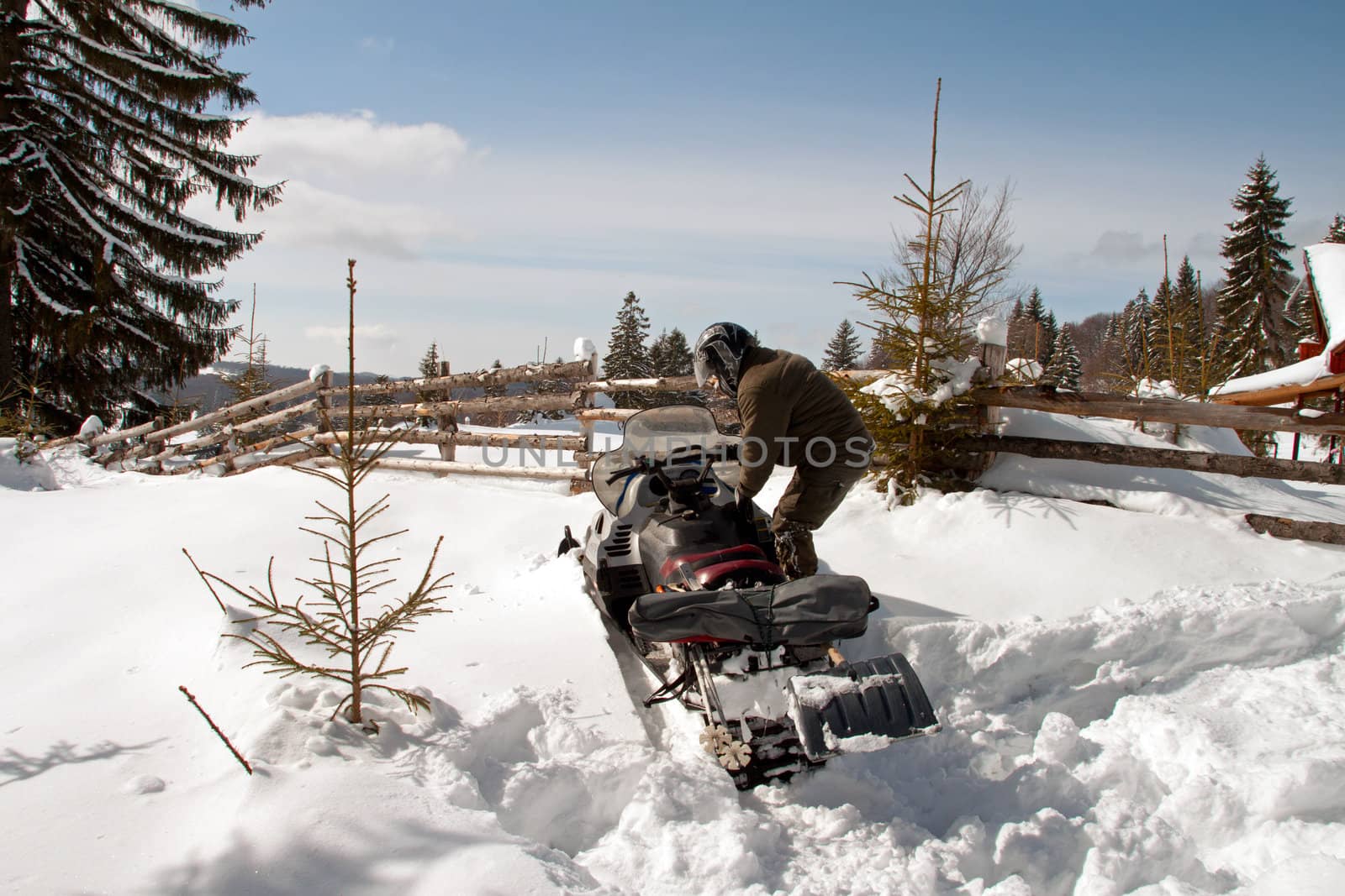 Man with a snowmobile by renegadewanderer