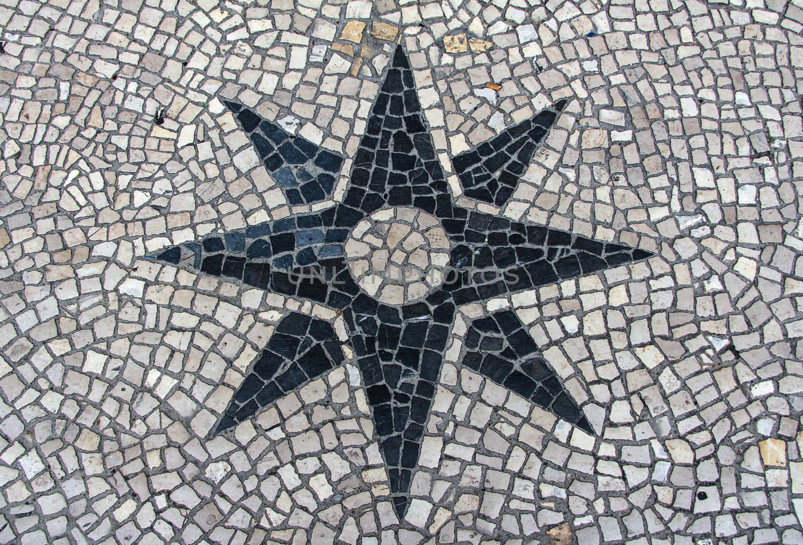 Clear stone blocks pavement texture with a dark central star motive for background