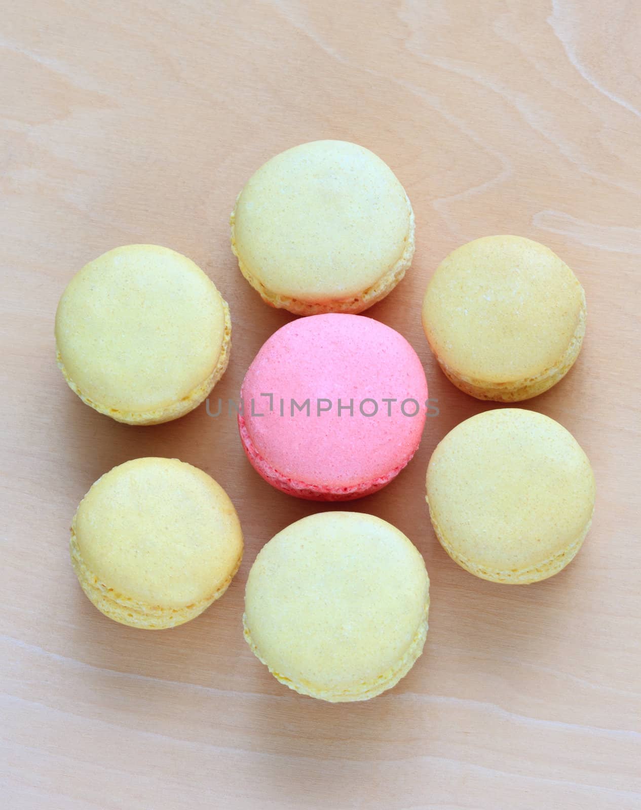 Colorful macaroons on wooden background by sfinks