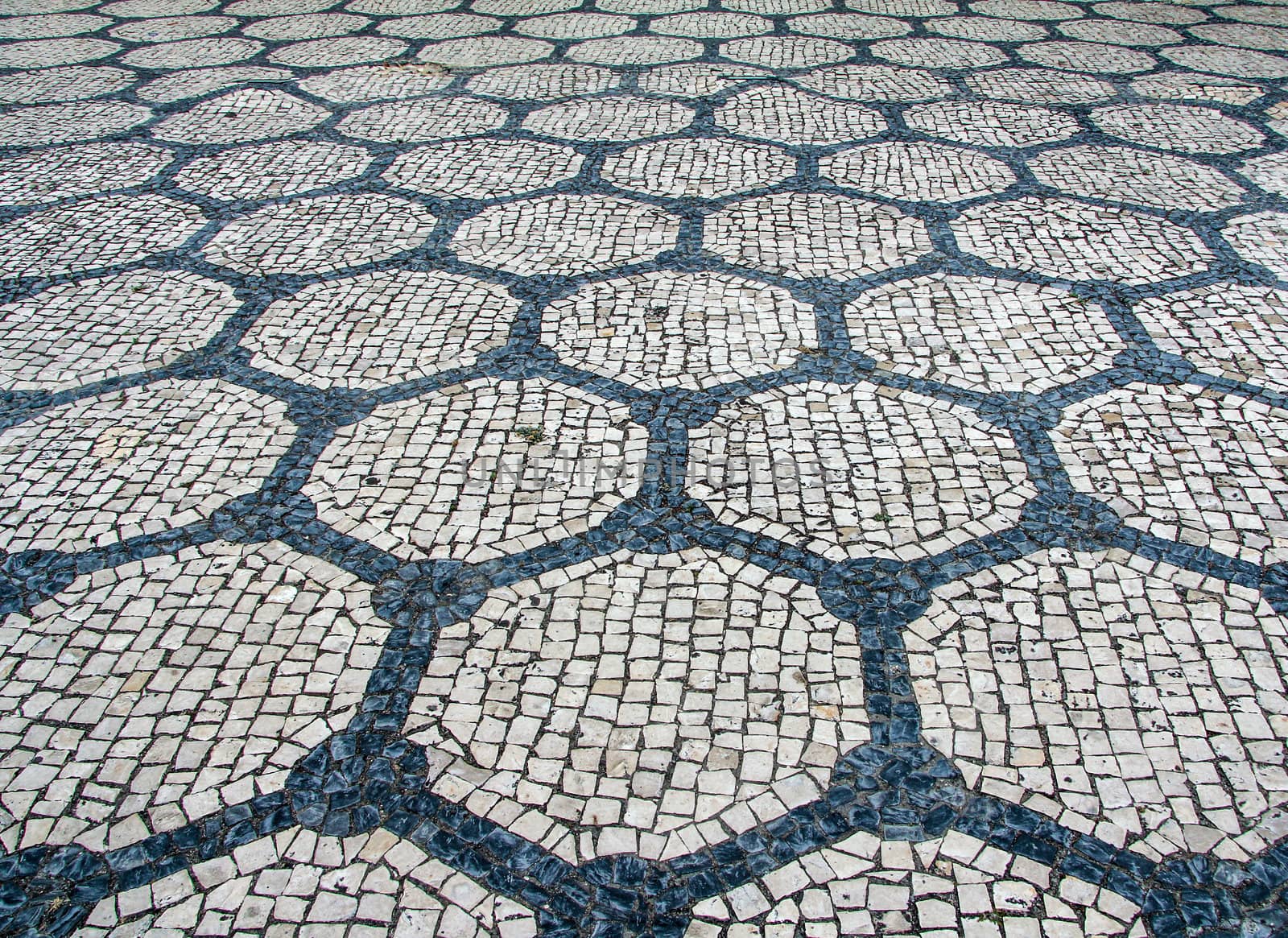 Clear stone blocks pavement texture with a dark central hexagons motive for background