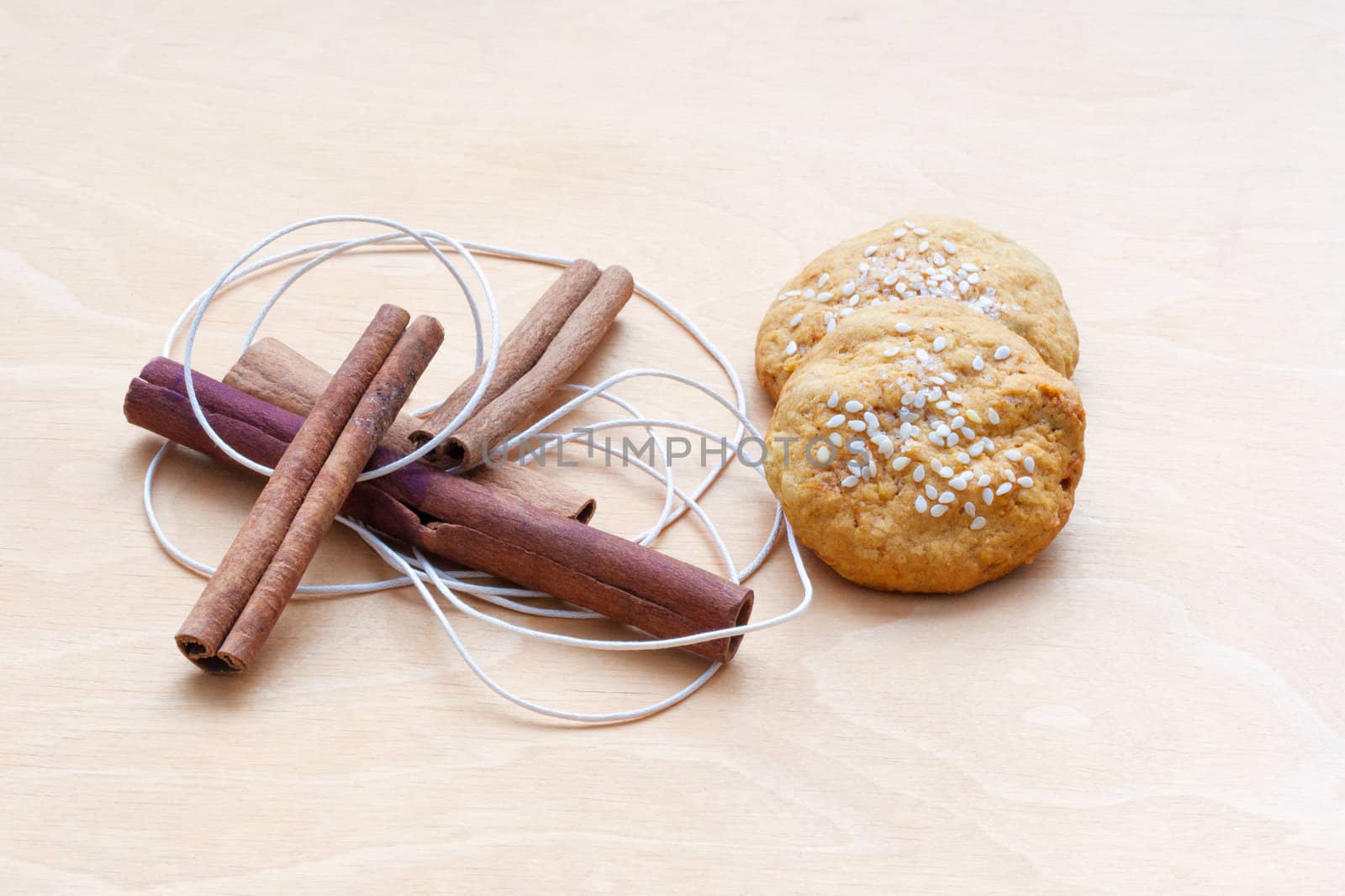 biscuits, cinnamon sticks and a cord by sfinks