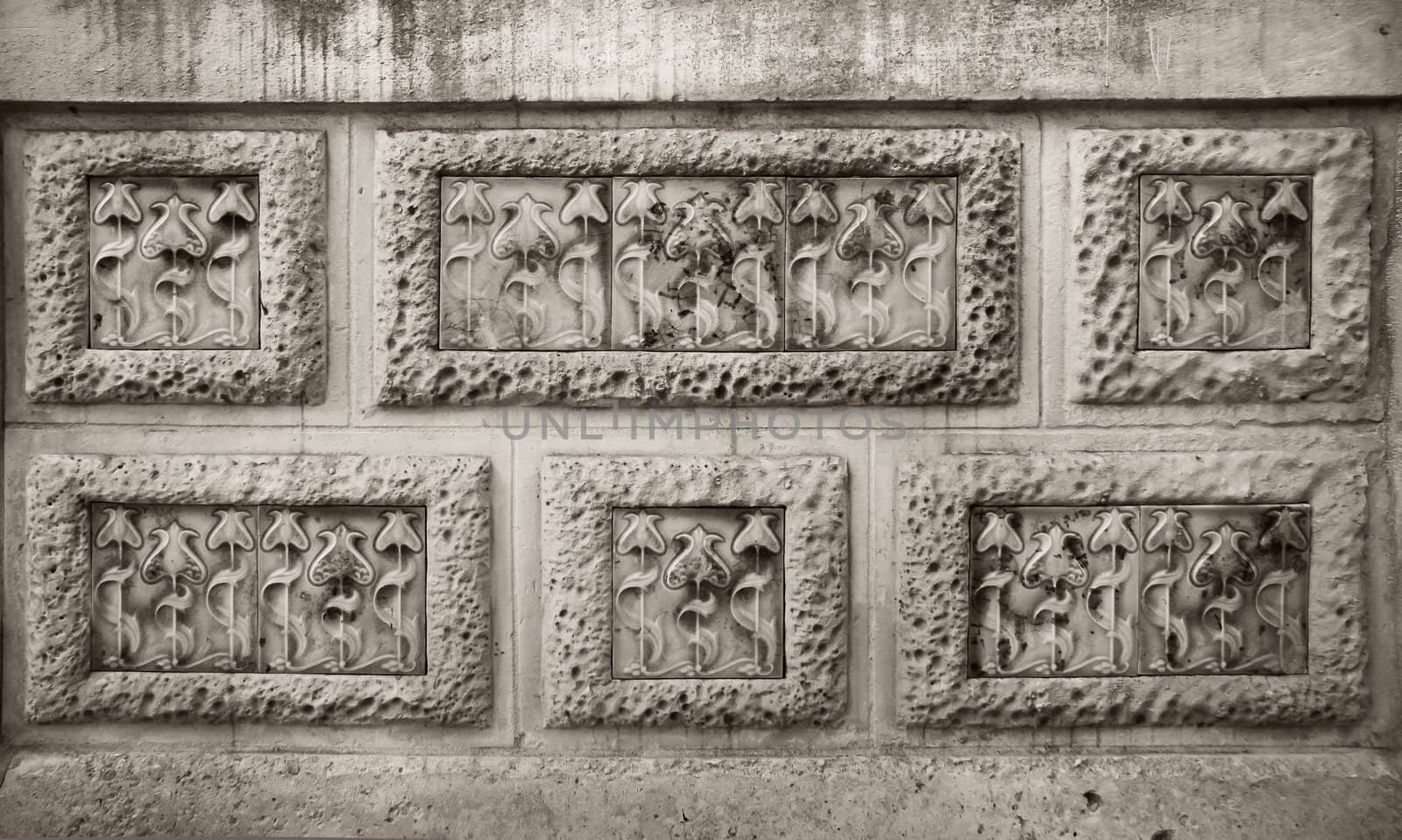 Detail of modernist flowers carving in stone wall rectangles