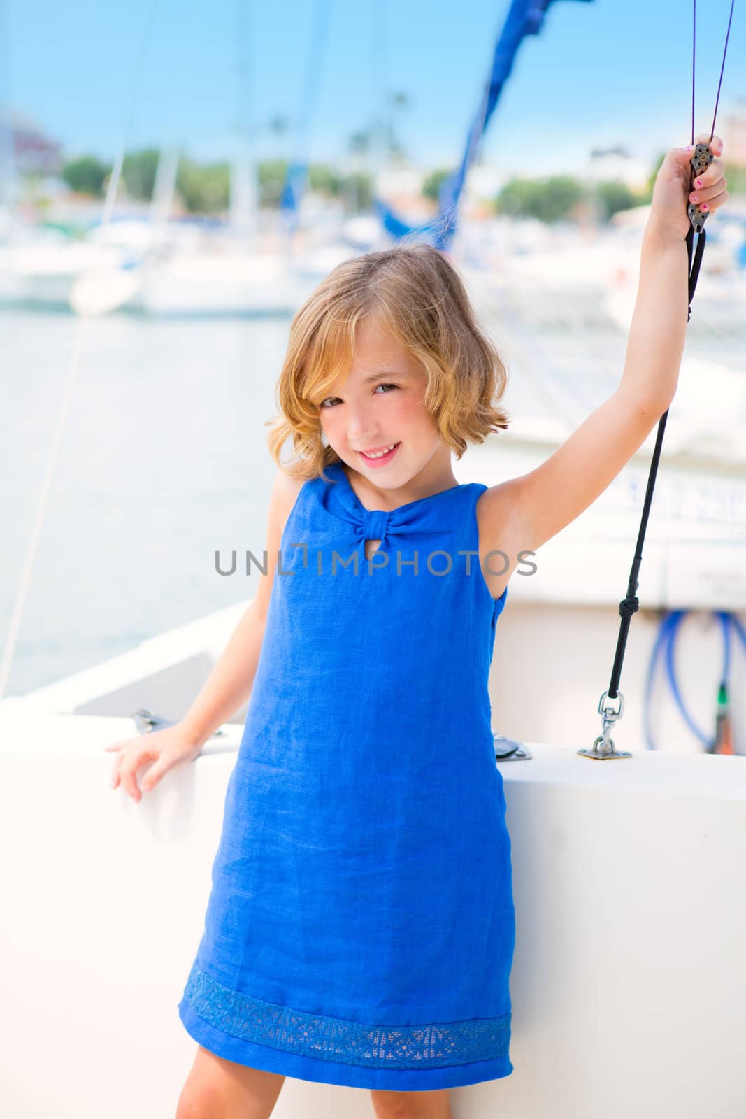 child kid girl in marina boat on summer vacations in Mediterranean