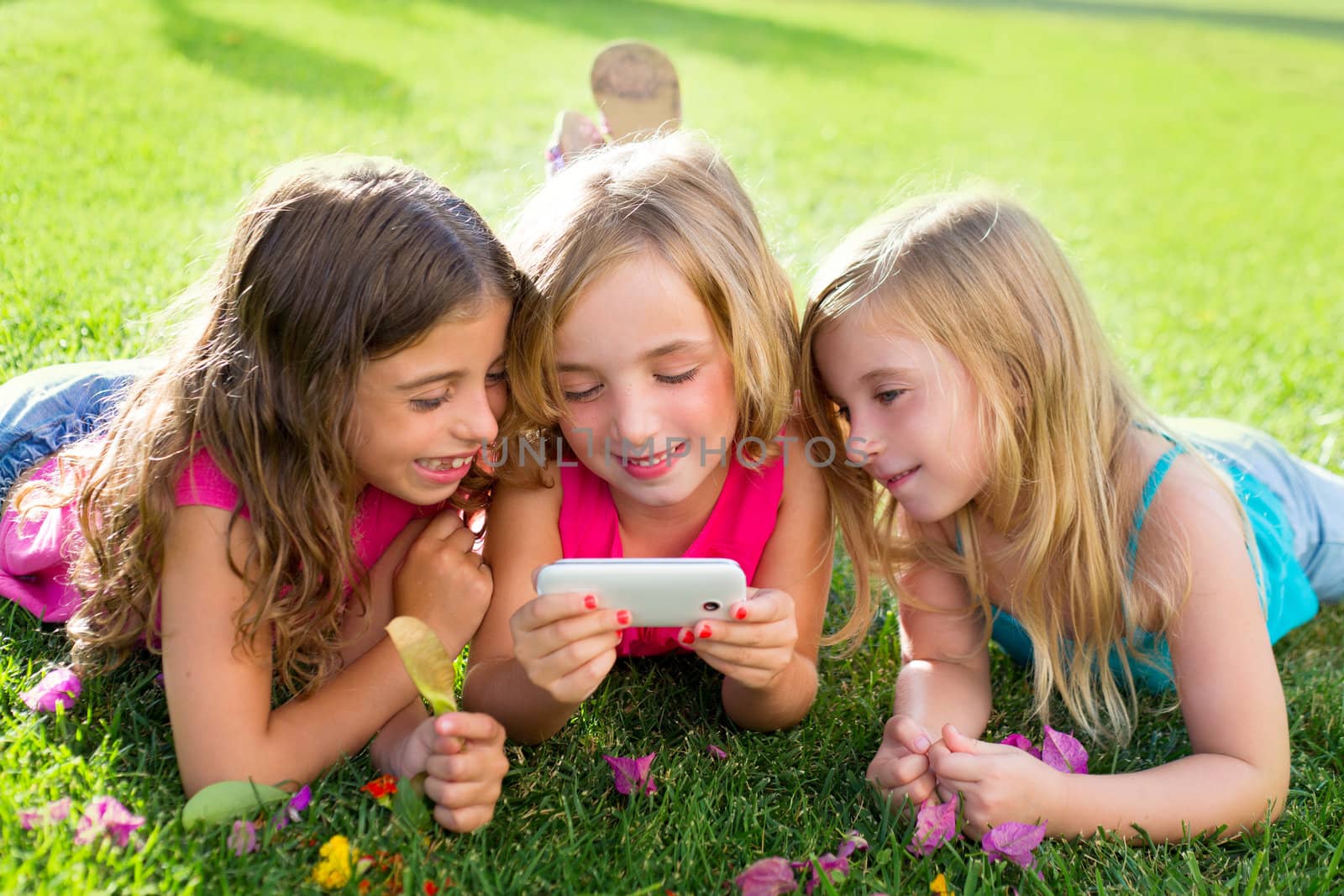 children friend girls playing internet with smartphone by lunamarina