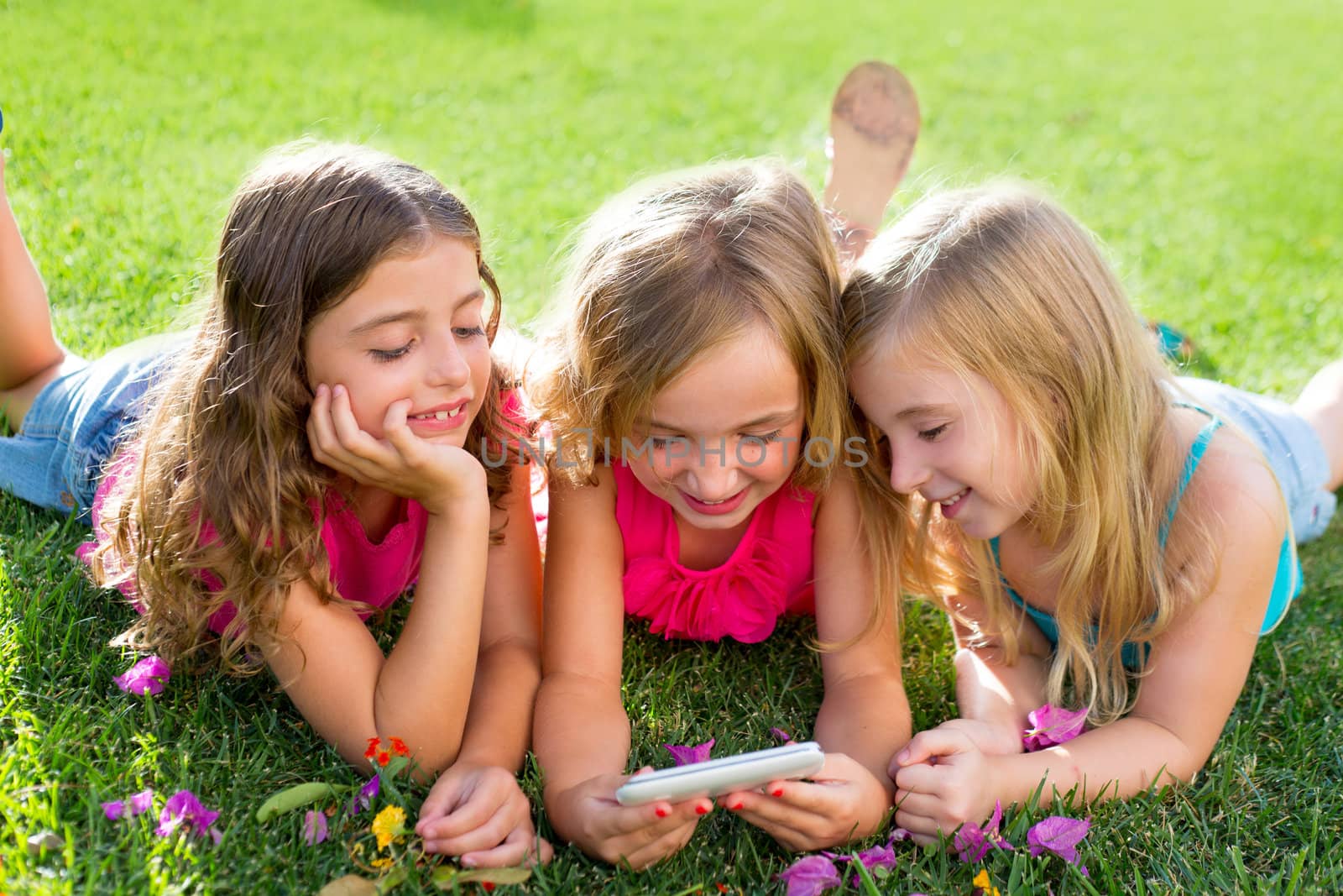 children friend girls playing internet with smartphone by lunamarina