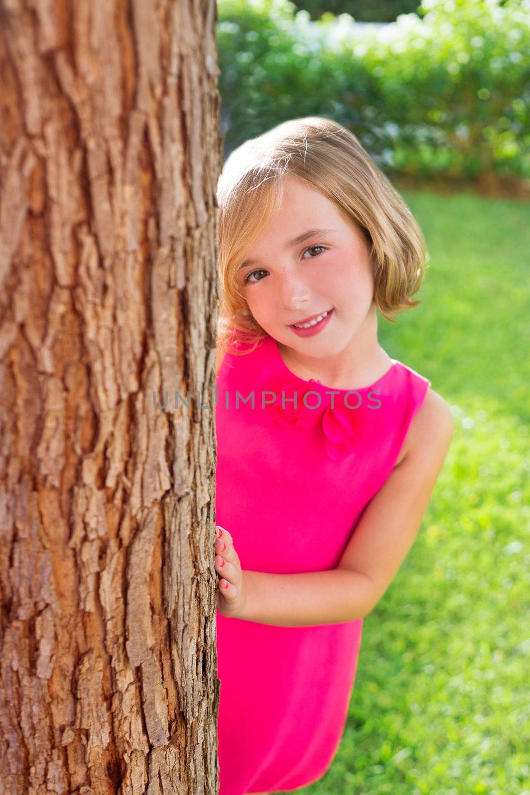 child happy girl smiling rear tree trunk in garden by lunamarina