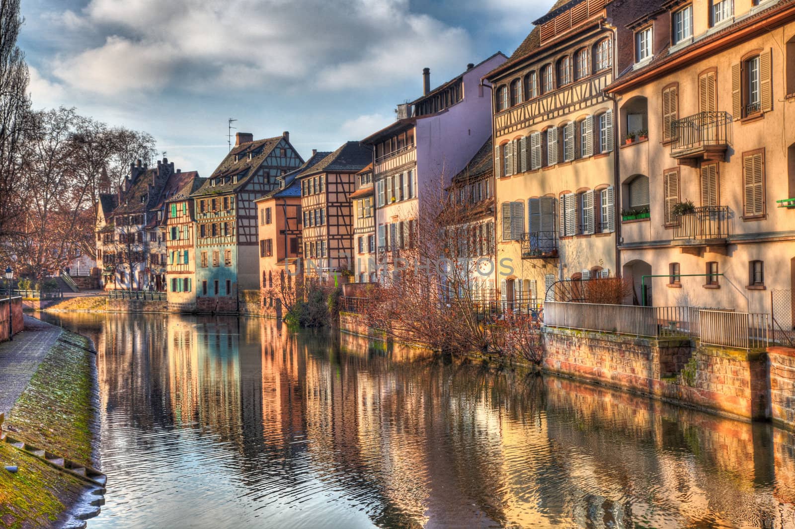 Beautiful reflections at the sunset of traditional buildings in a water canal in Strasbourg in eastern France.