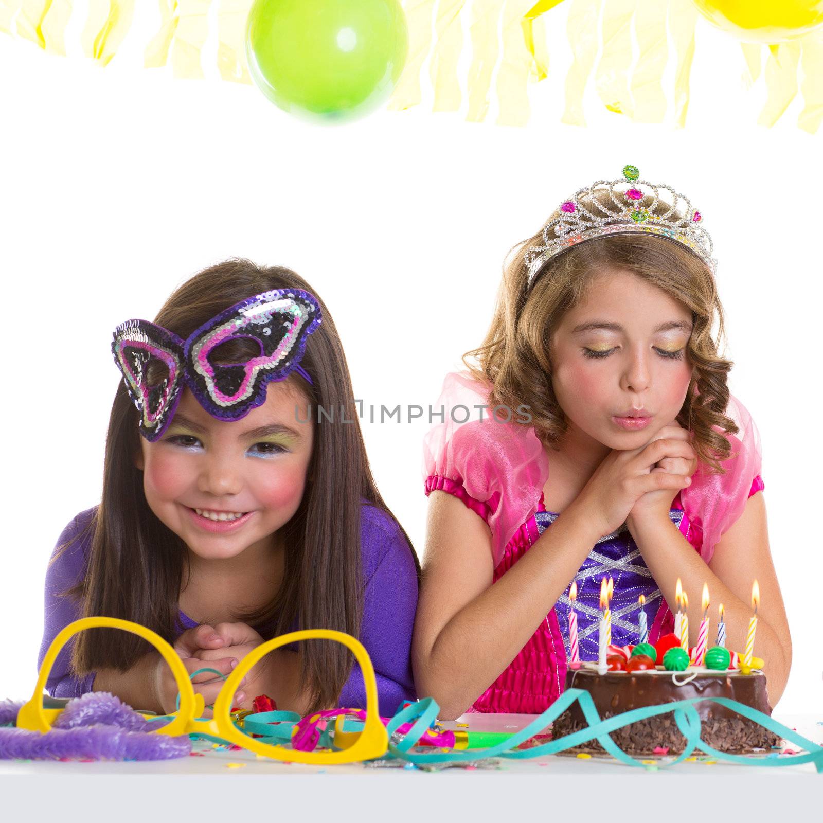 children happy girls blowing birthday party chocolate cake candles