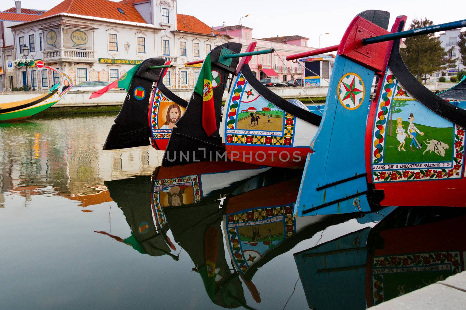 View of handmade paints in traditional moliceiro boats, in a canal of Aveiro, Portugal