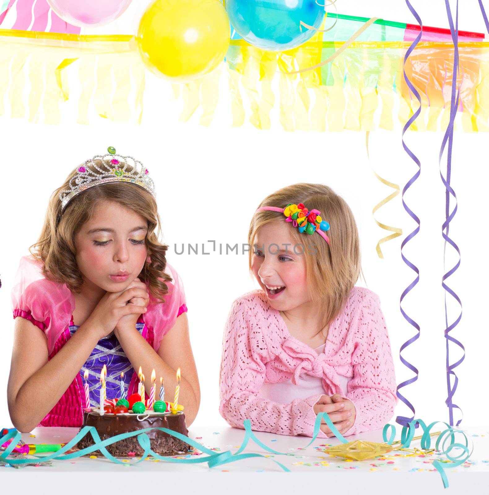 children happy girls blowing birthday party chocolate cake candles