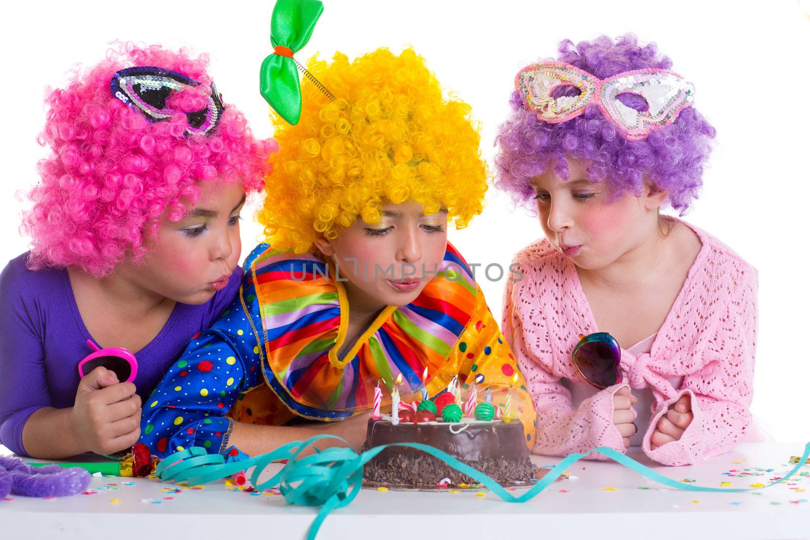 Children birthday party clown wigs blowing cake candles by lunamarina