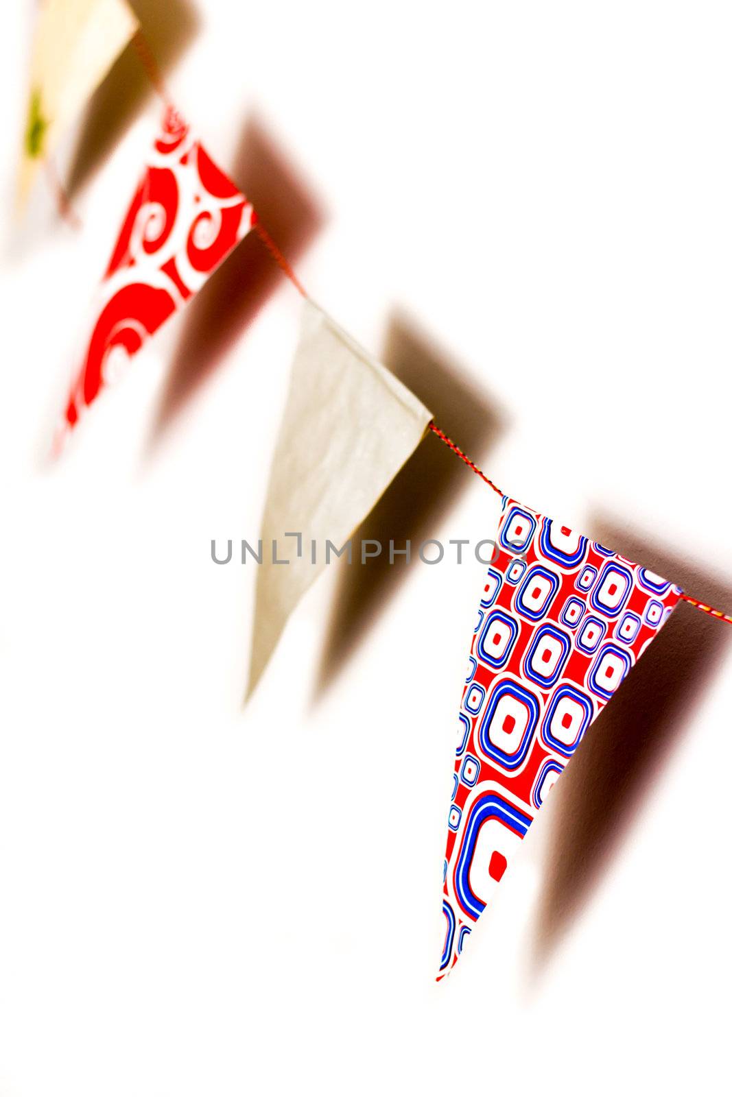 Detail of pattern triangles in a bunting flags with shadows on white background