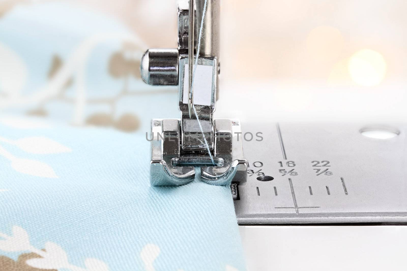 Close up of a sewing machine needle and fabric. Shallow depth of field.