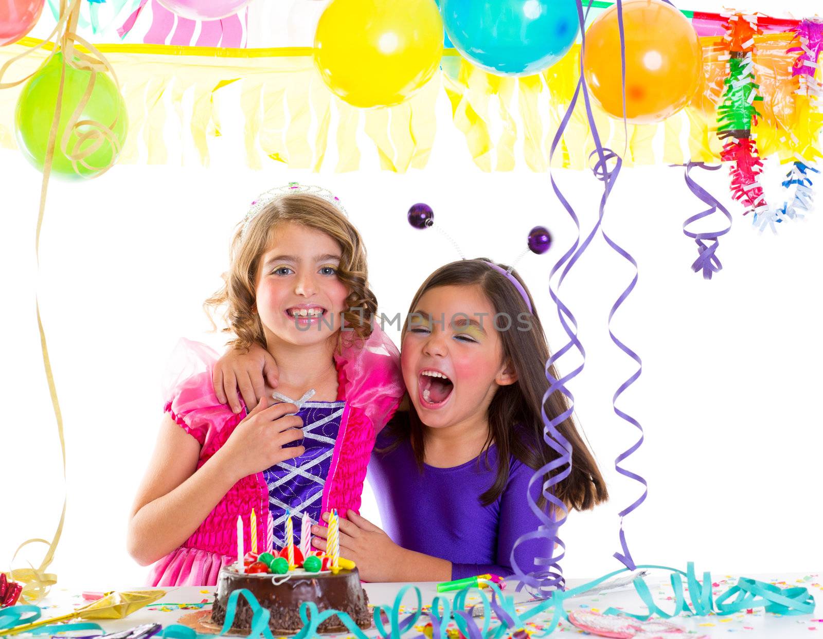 children happy hug in birthday party laughing with baloons garlands and candles cake