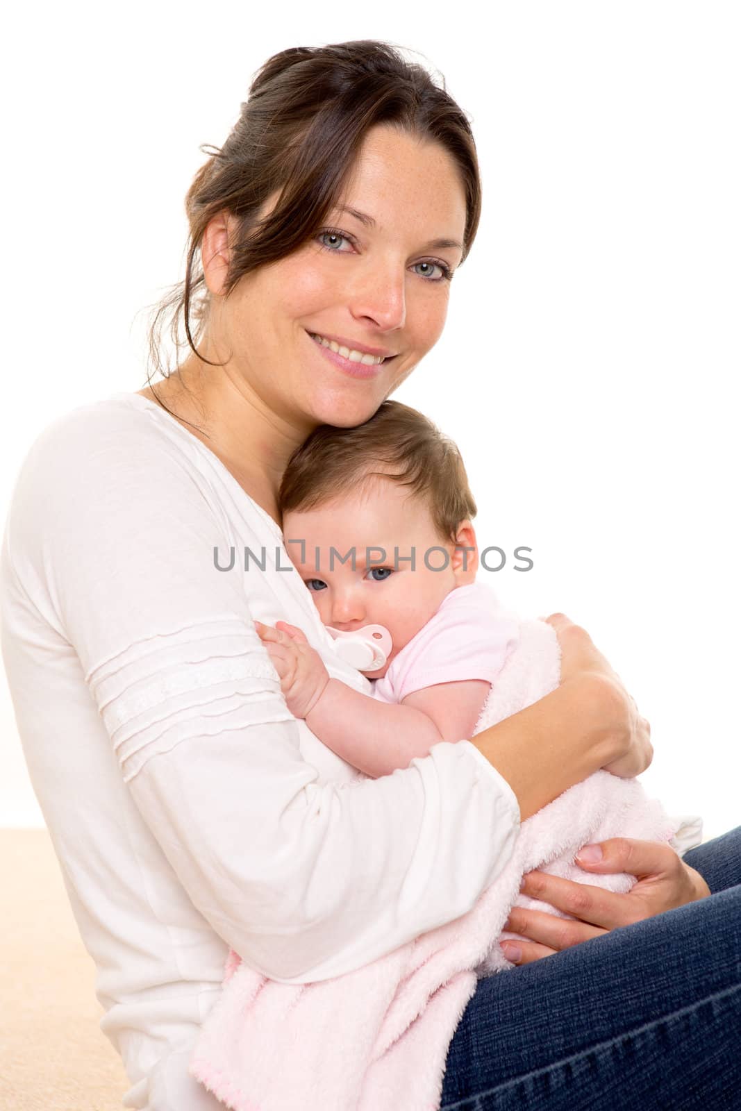 Baby girl relaxed with pacifier hug in mother arms on white background