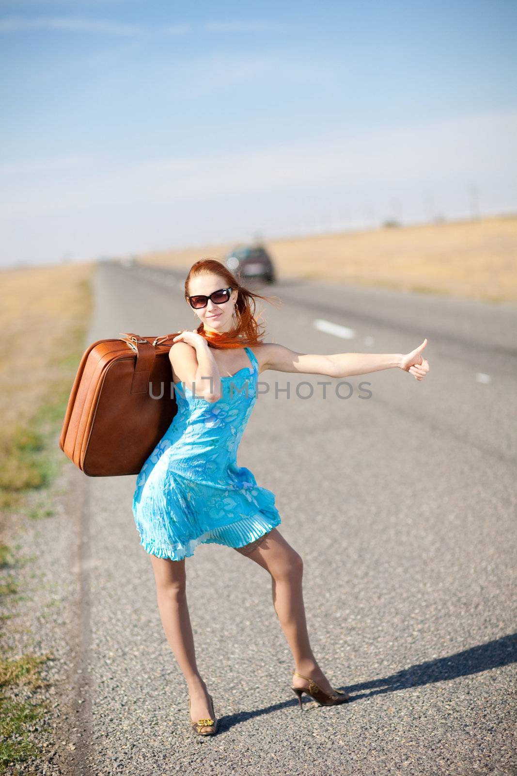 girl on the road waiting for a car