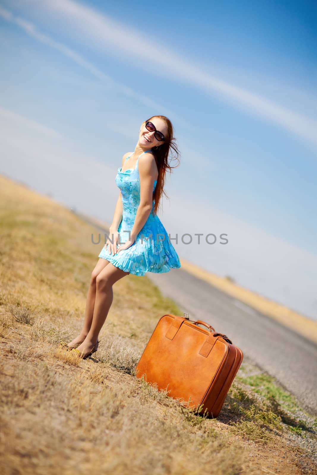 laughing girl near the suitcase