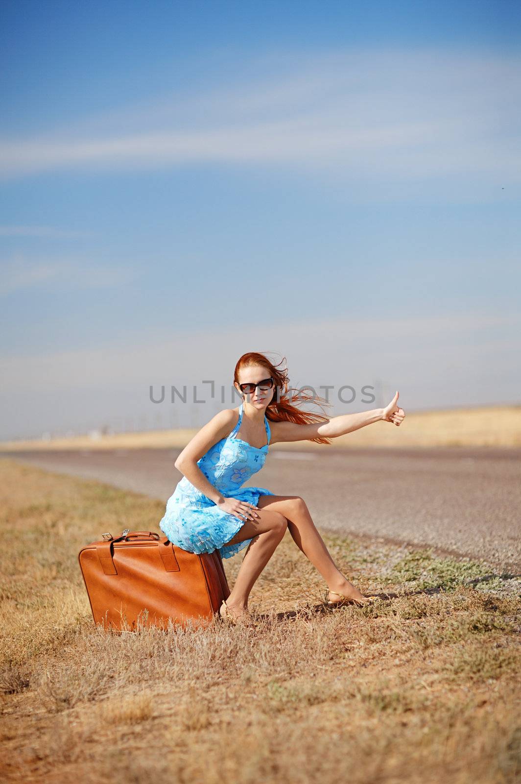 girl on the road waiting for a car