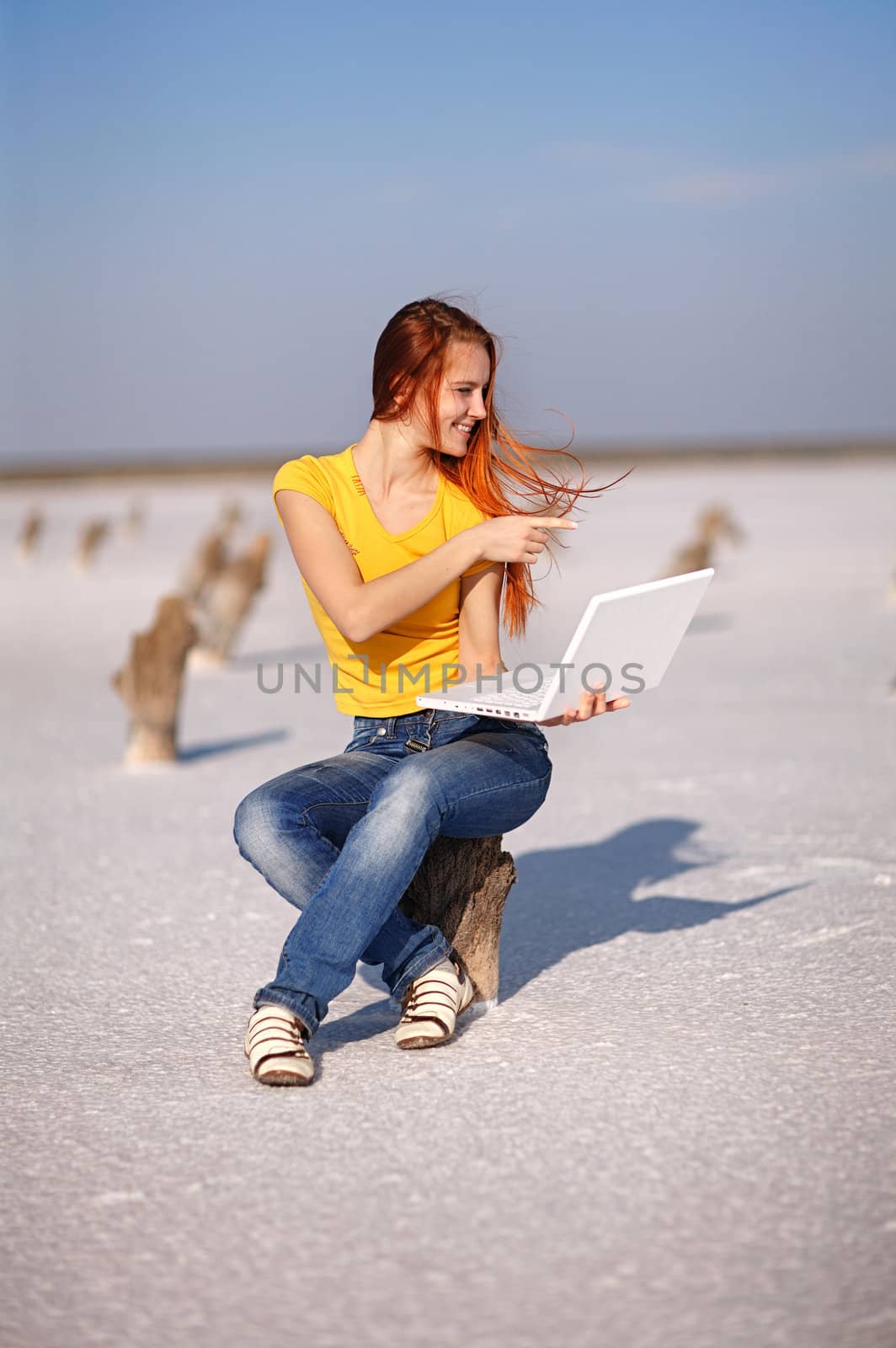 girl with notebook on the sand