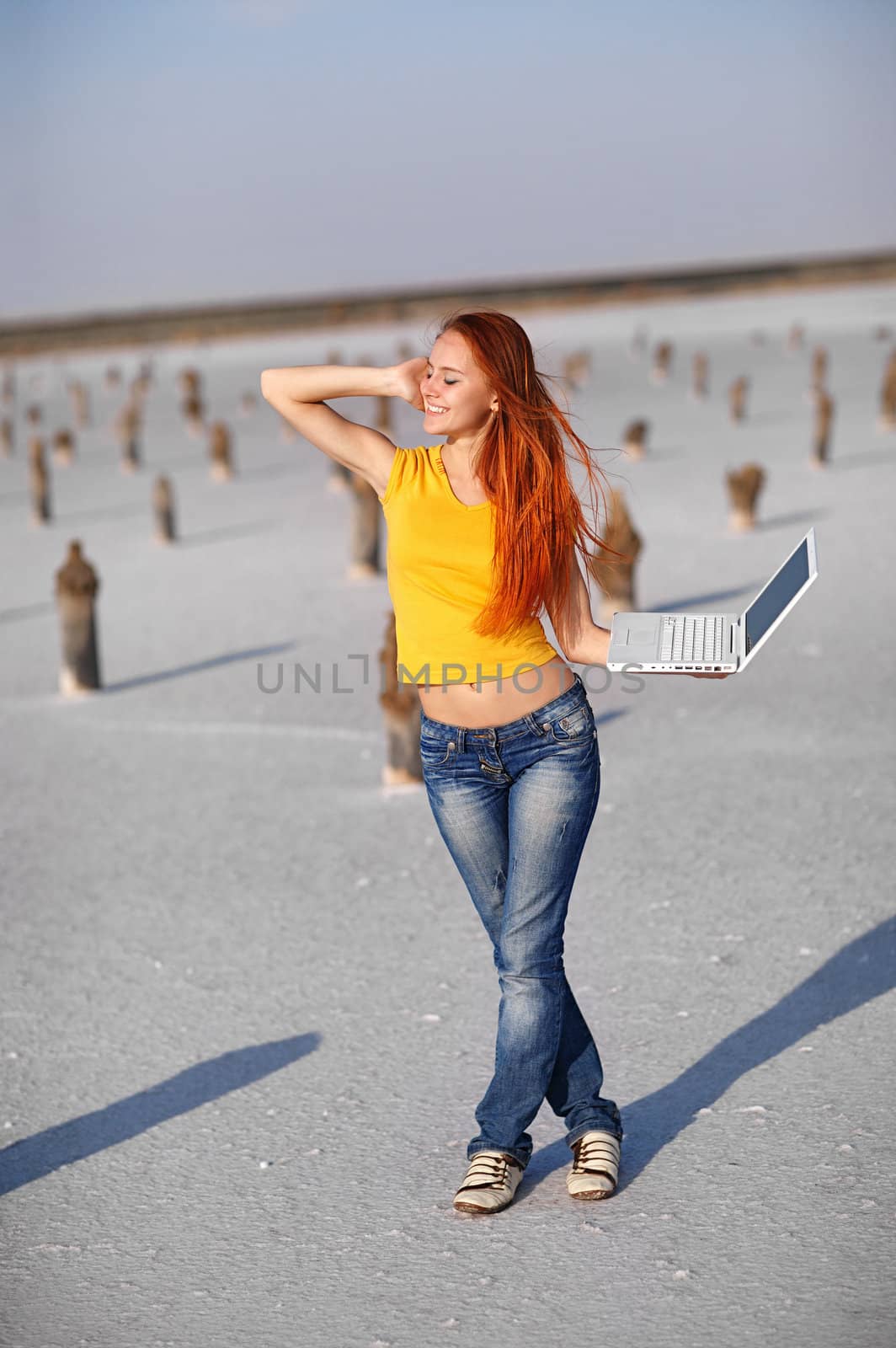 happy girl with notebook on the sand 