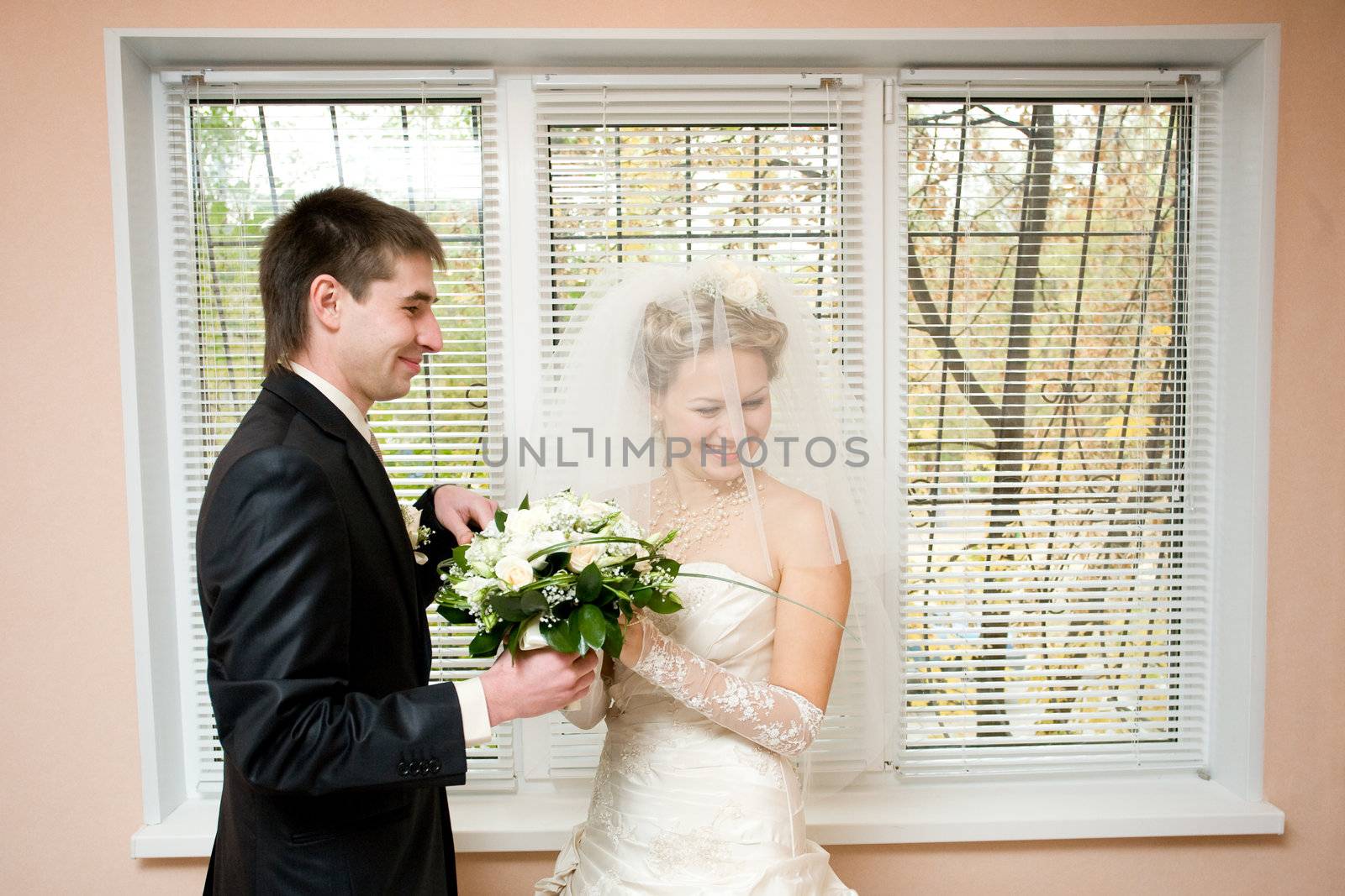 groom gives flowers to the bride