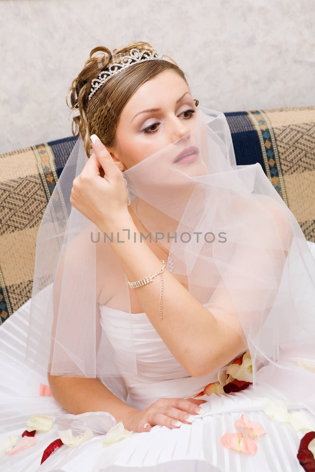 smiling bride playing with the veil