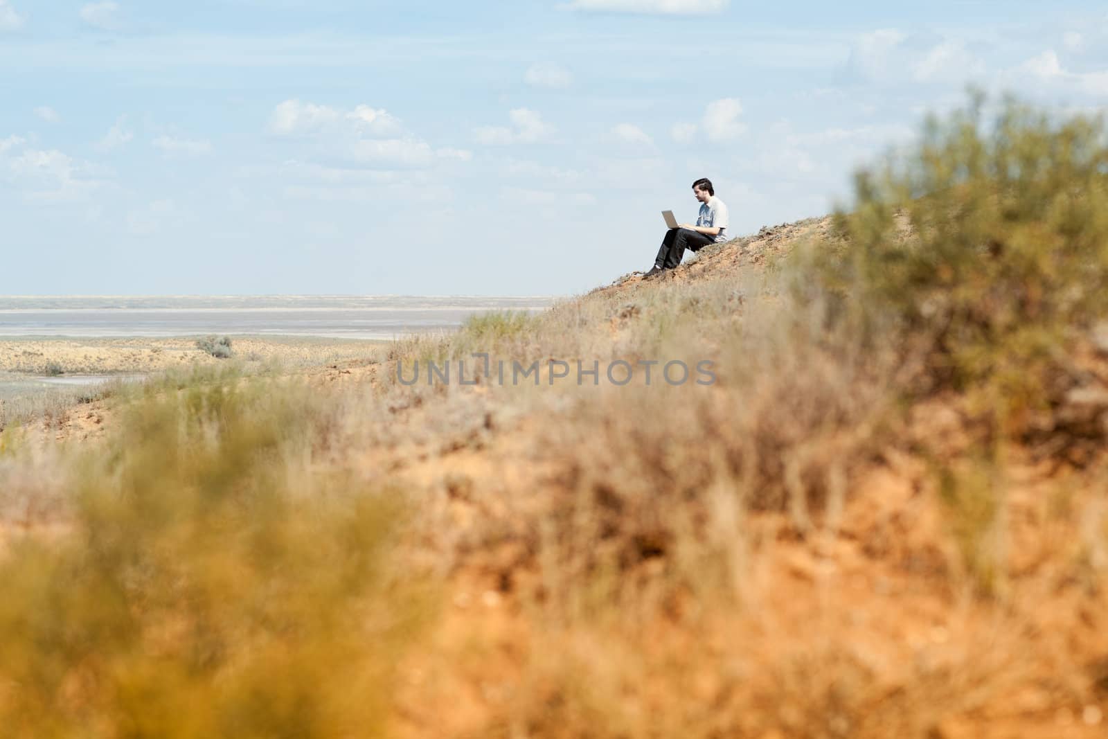 man with laptop on the hill